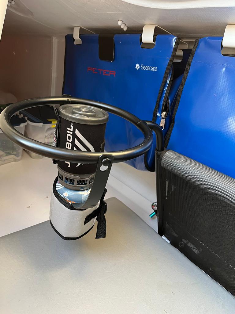 Compact interior of a 2018 Seascape 27 with a portable stove setup.