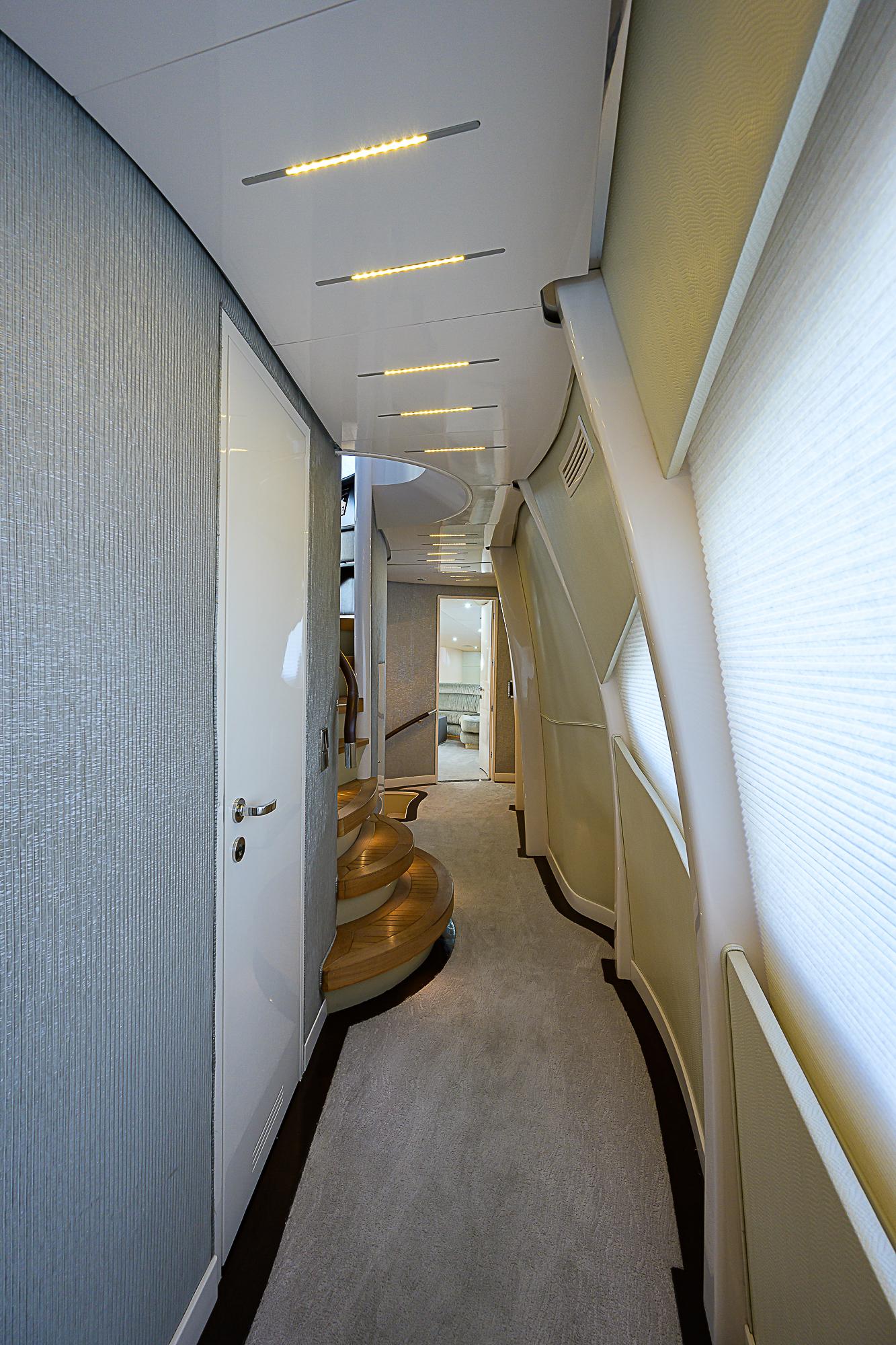 Luxurious hallway inside 2005 DMB Danube Motor Yacht, featuring modern design and elegant lighting.