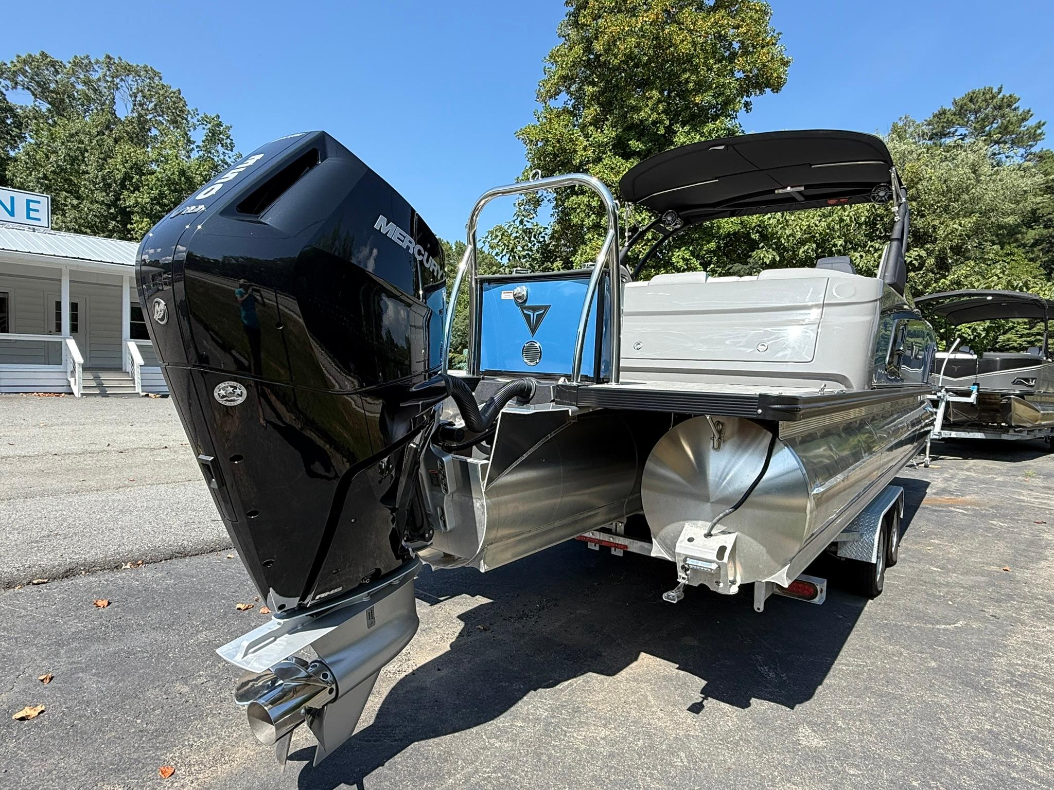 2025 Tahoe Pontoon Grand Tahoe Elite Windshield with Mercury outboard engine, parked outdoors.