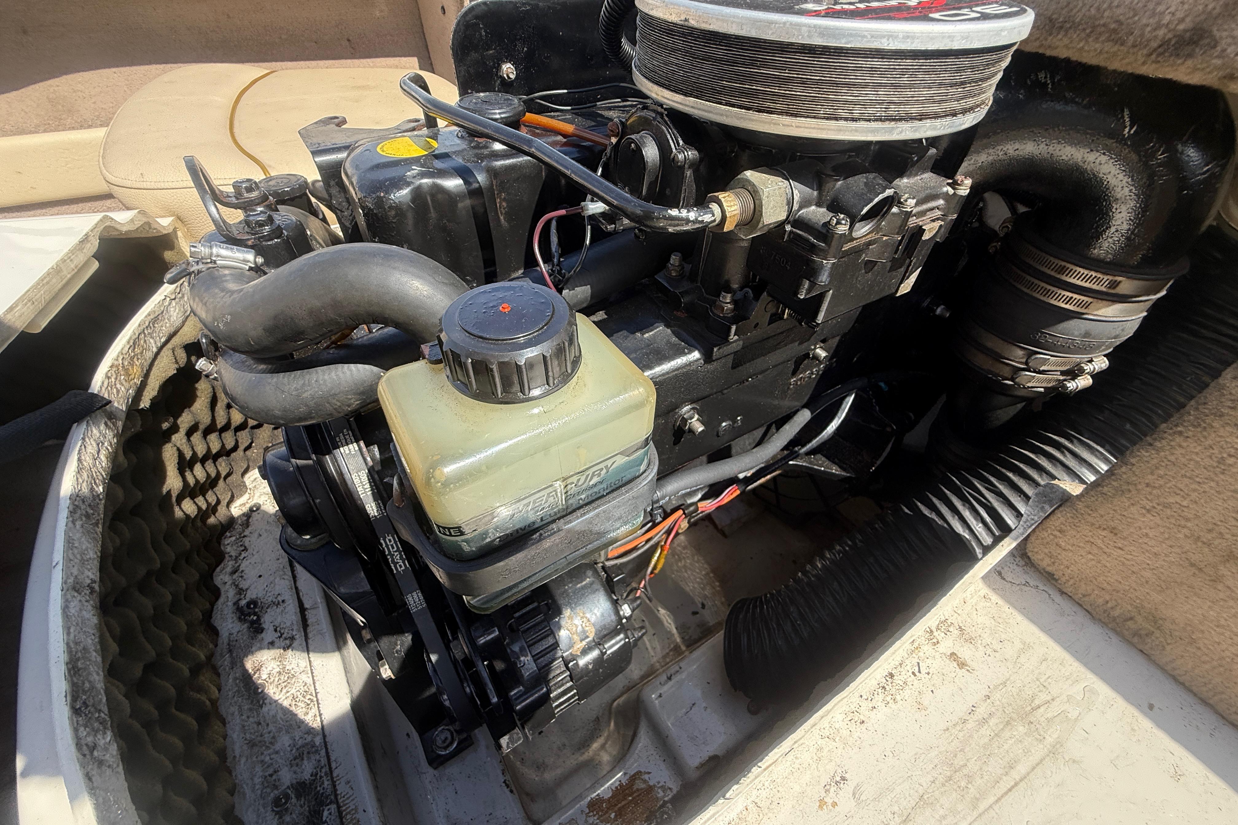 Engine compartment of a 2001 Sea Ray 180 Bow Rider boat, showcasing mechanical components.