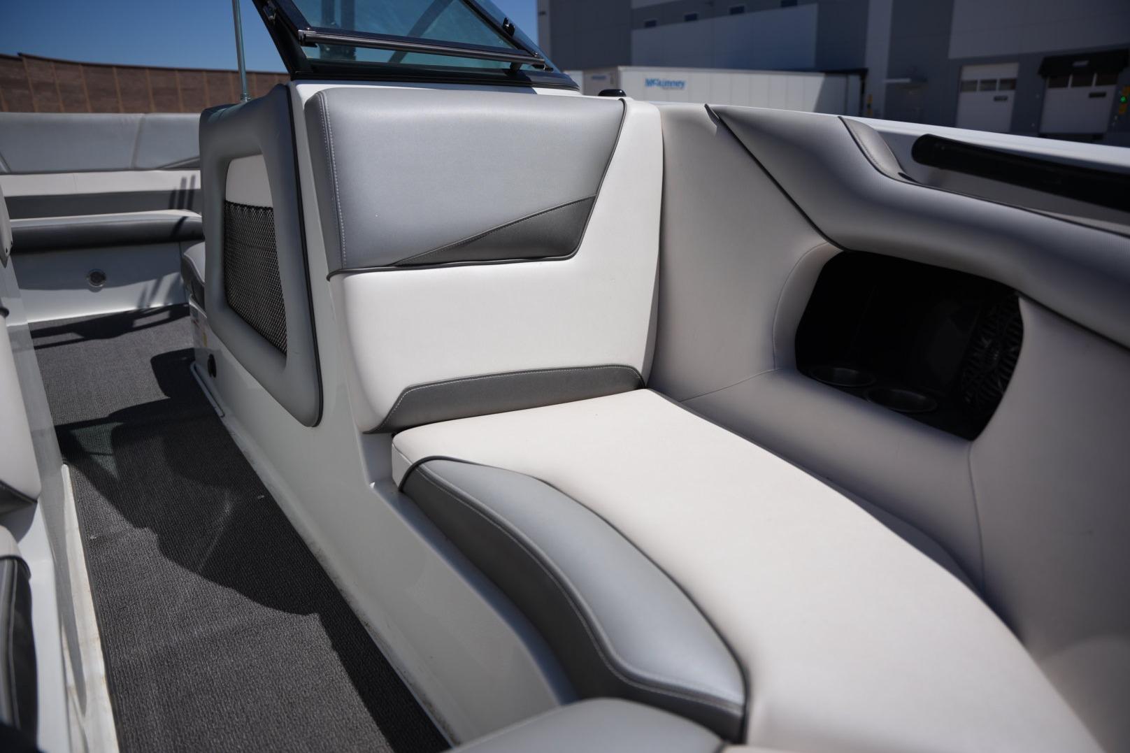 Interior of a 2016 Supreme S211 boat, featuring sleek gray and white seating.