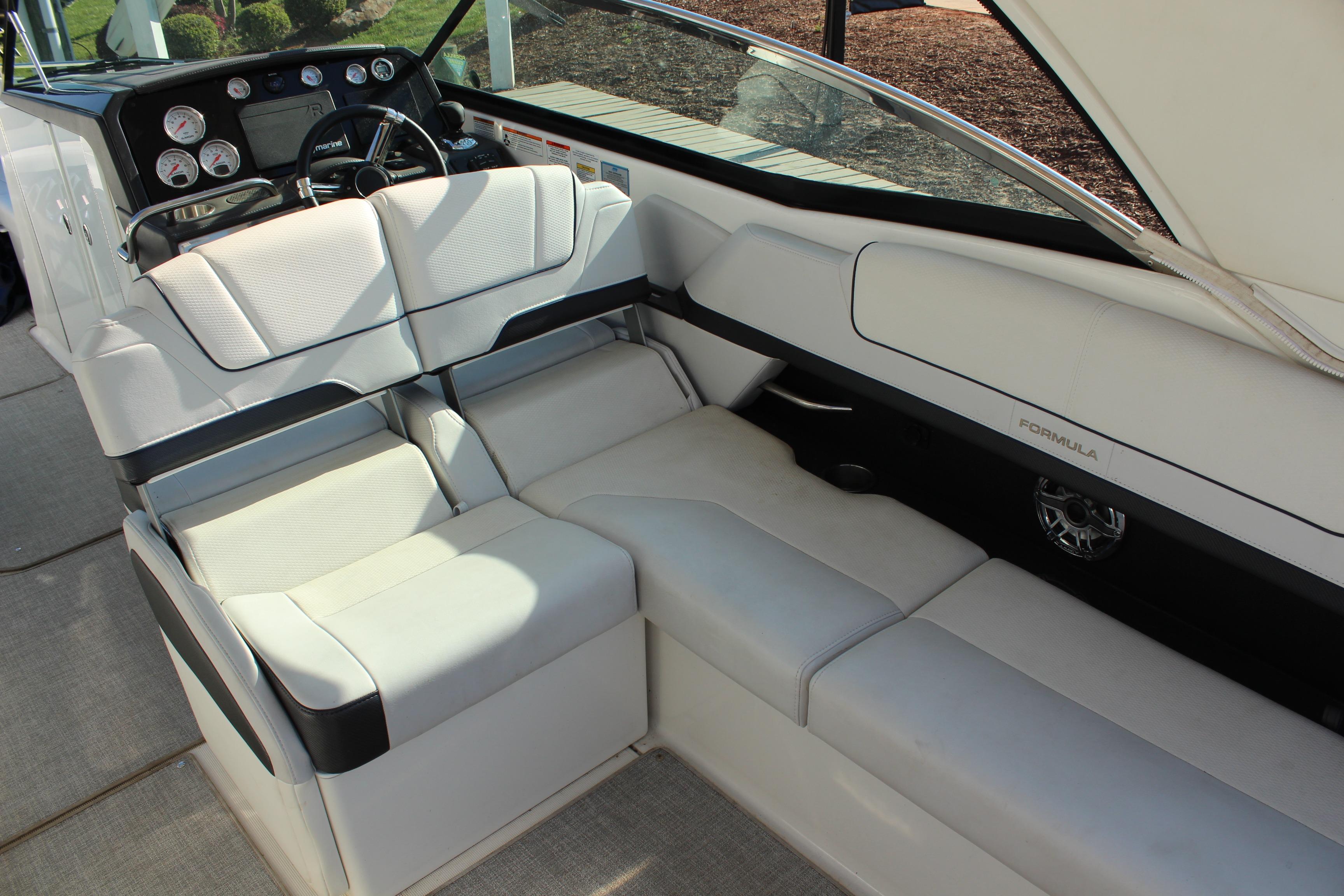 2023 Formula 310 Bowrider I/O interior with luxurious white seating and modern dashboard.