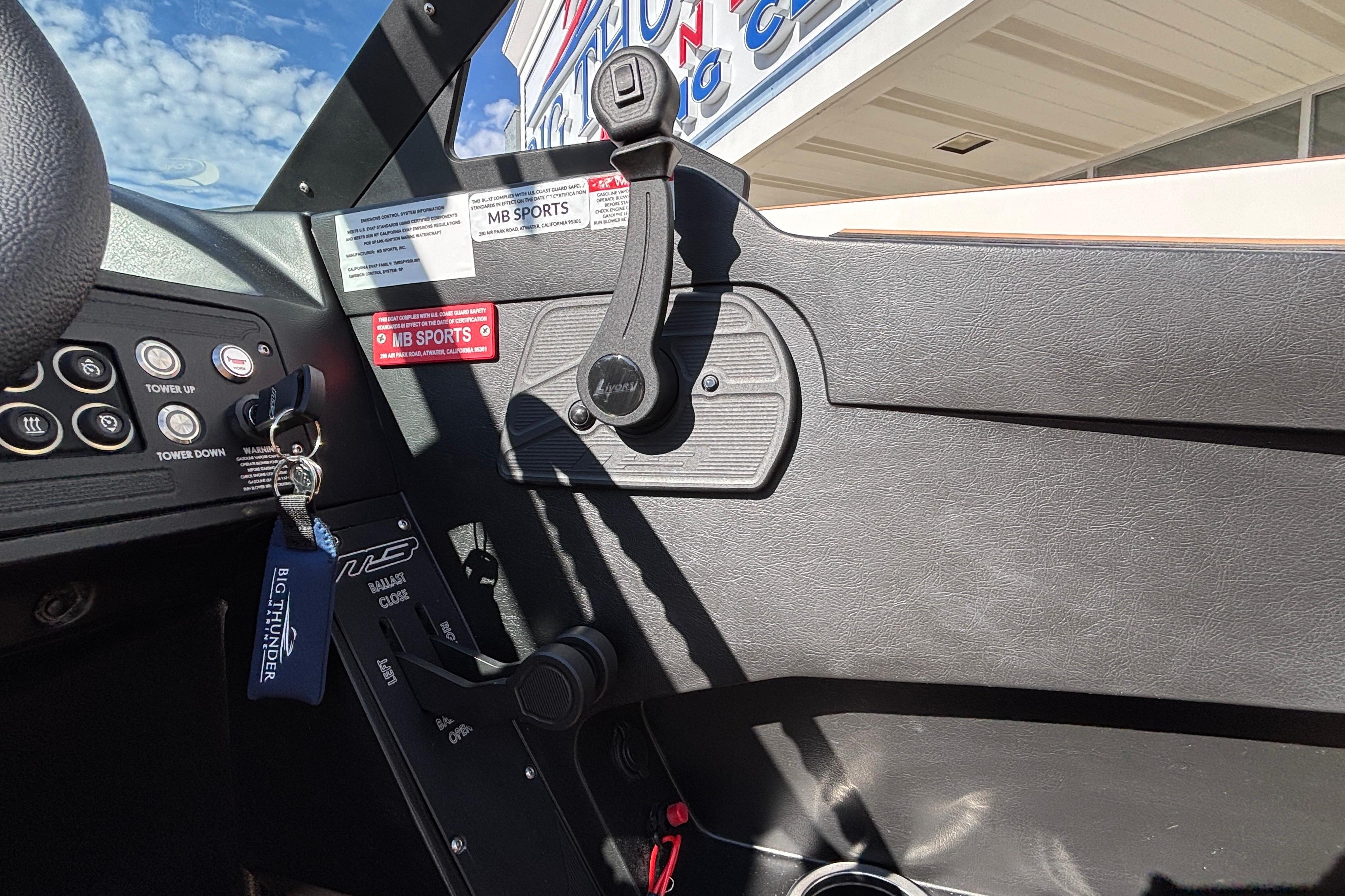 Interior view of 2026 MB SPORTS F21 Classic boat dashboard with controls and branding.
