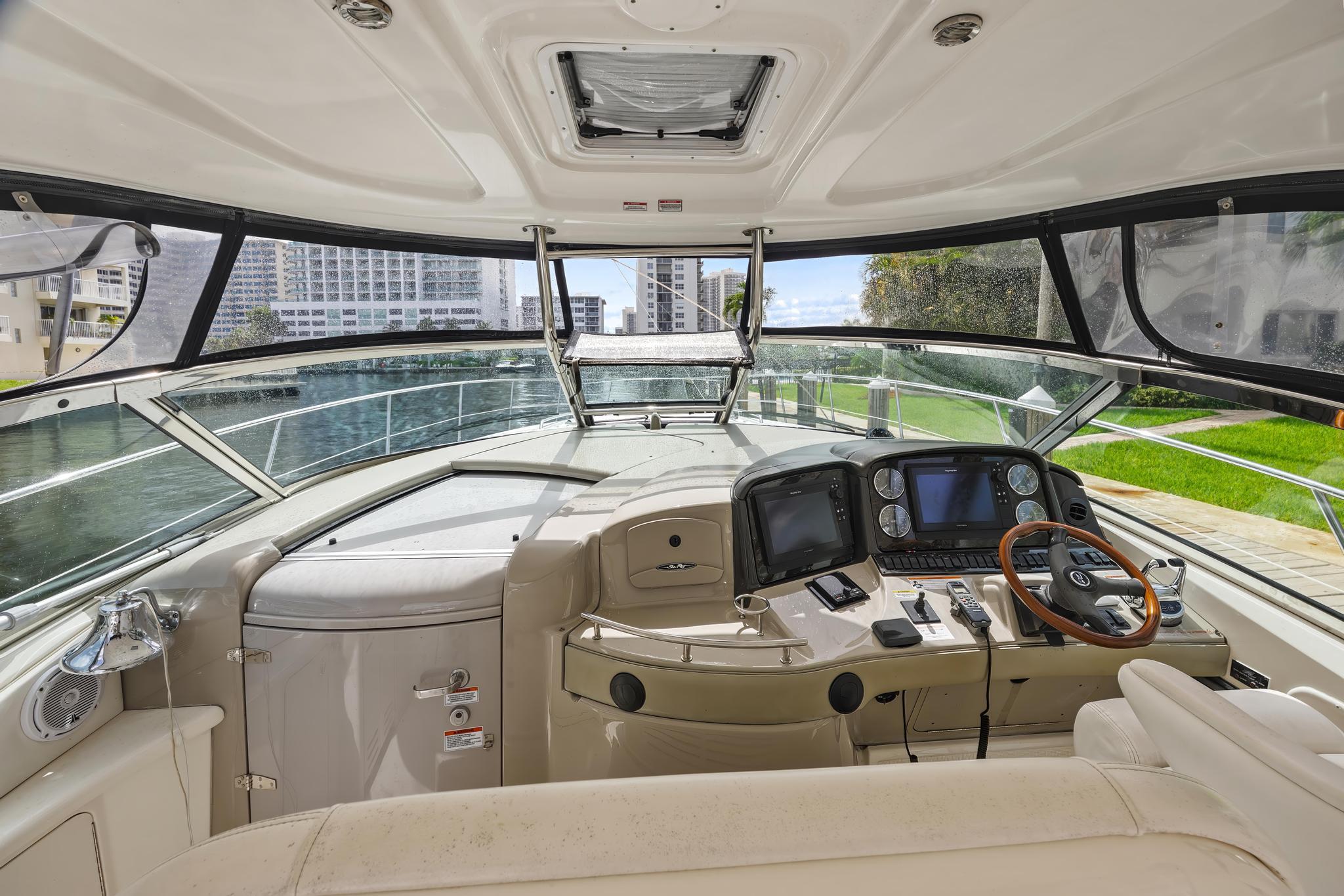 2008 Sea Ray 44 Sundancer yacht cockpit with modern navigation equipment and luxurious seating.