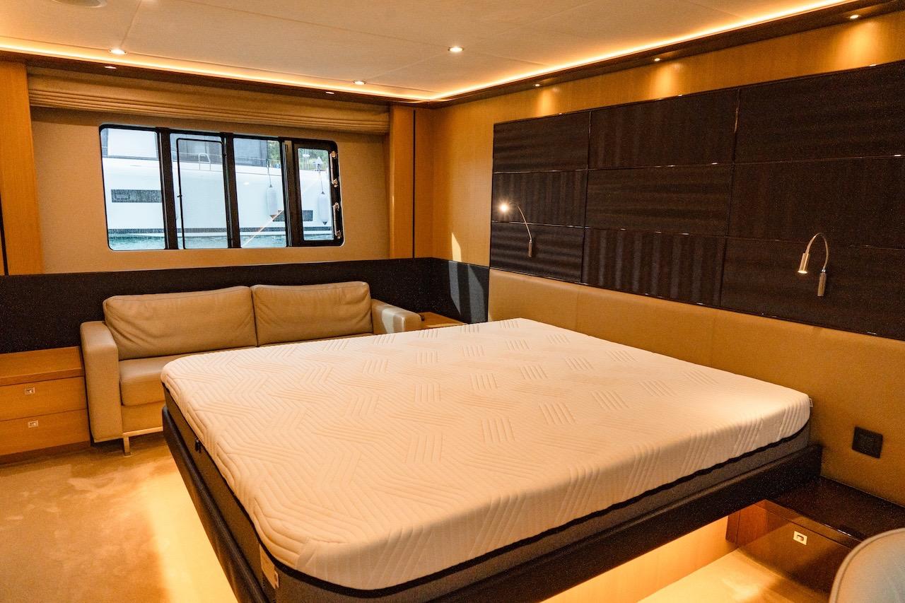 Luxurious bedroom interior of 2012 Princess V72 yacht with modern design and cozy lighting.