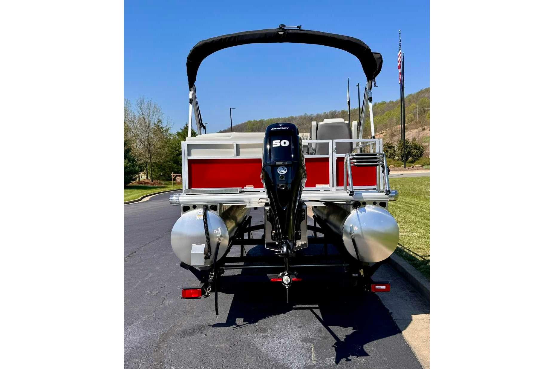 2026 Sun Tracker Bass Buggy 16 XL Select pontoon boat with 50 HP motor, rear view.