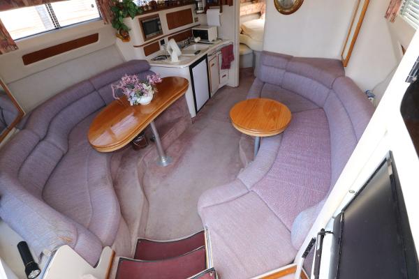 Interior of 1992 Sea Ray 350 Express Bridge with cozy seating and dining area.