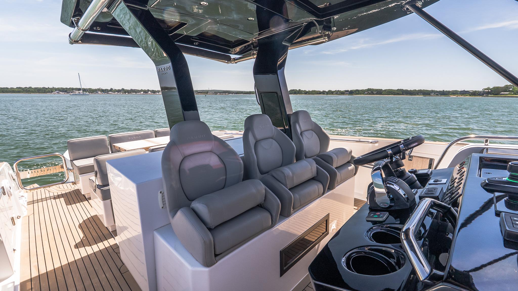 Luxurious 2023 Pardo Yachts 38 interior with sleek seating and modern helm on open water.