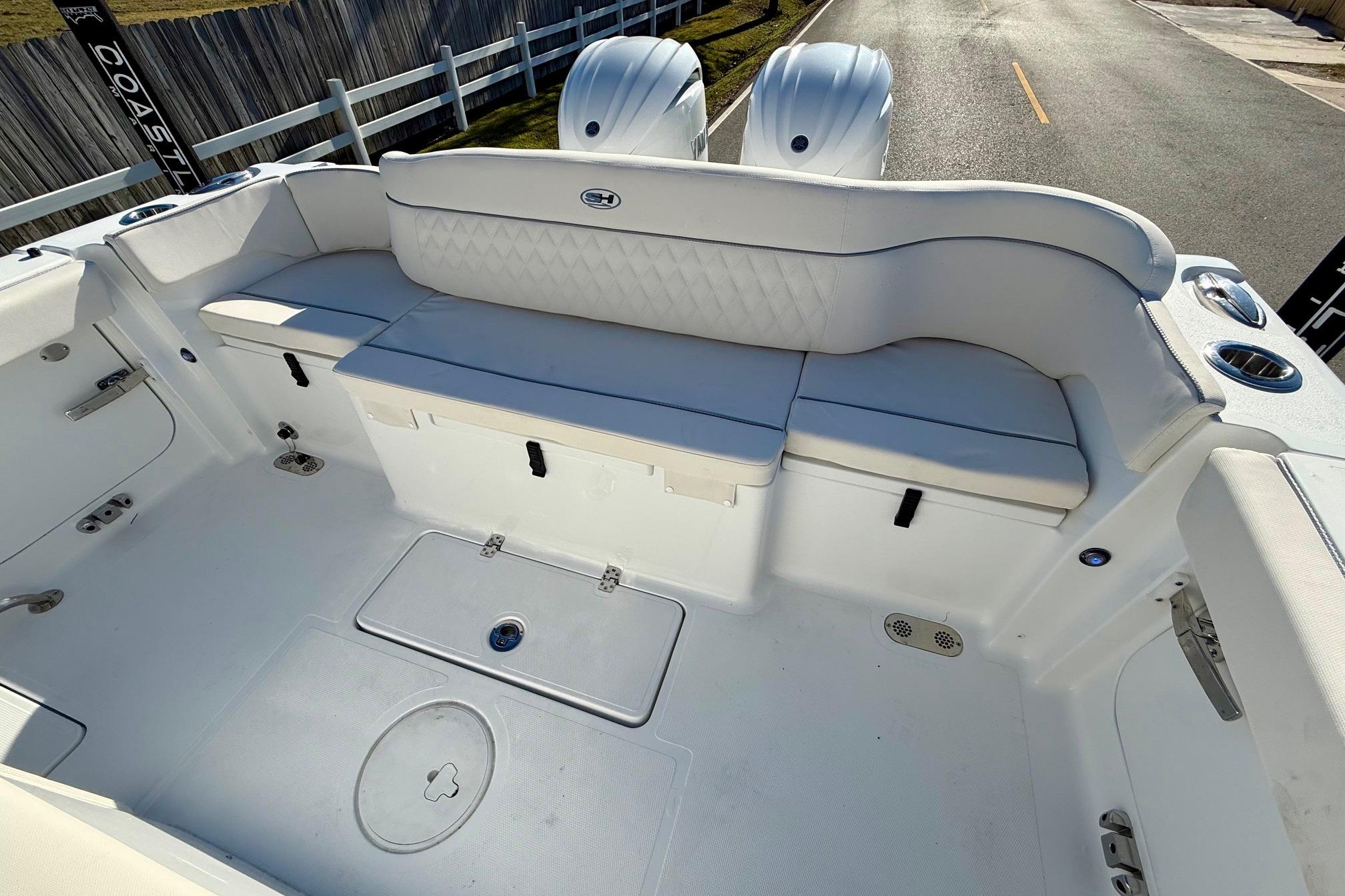 2026 Sea Hunt Ultra 275 Coffin Box boat interior with white seating and storage compartments.