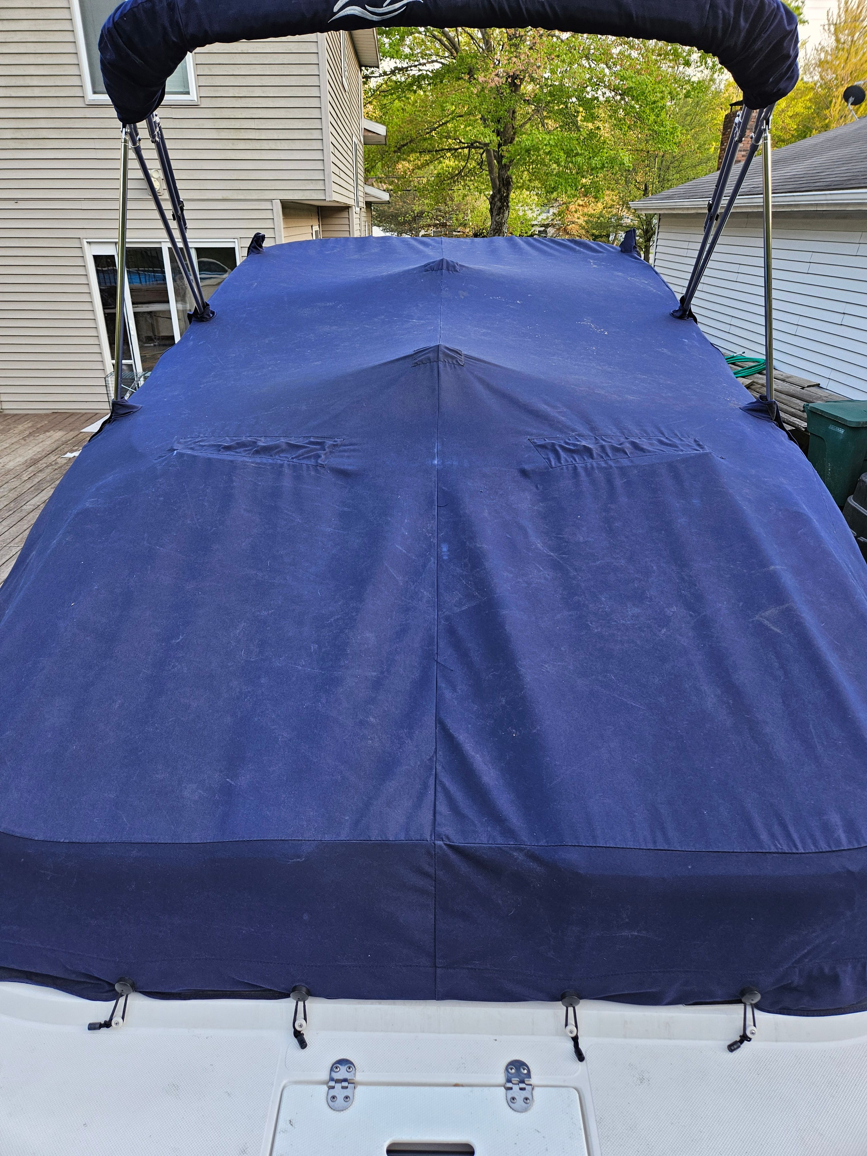 Covered Rinker Captiva DB boat in backyard, year 2009.