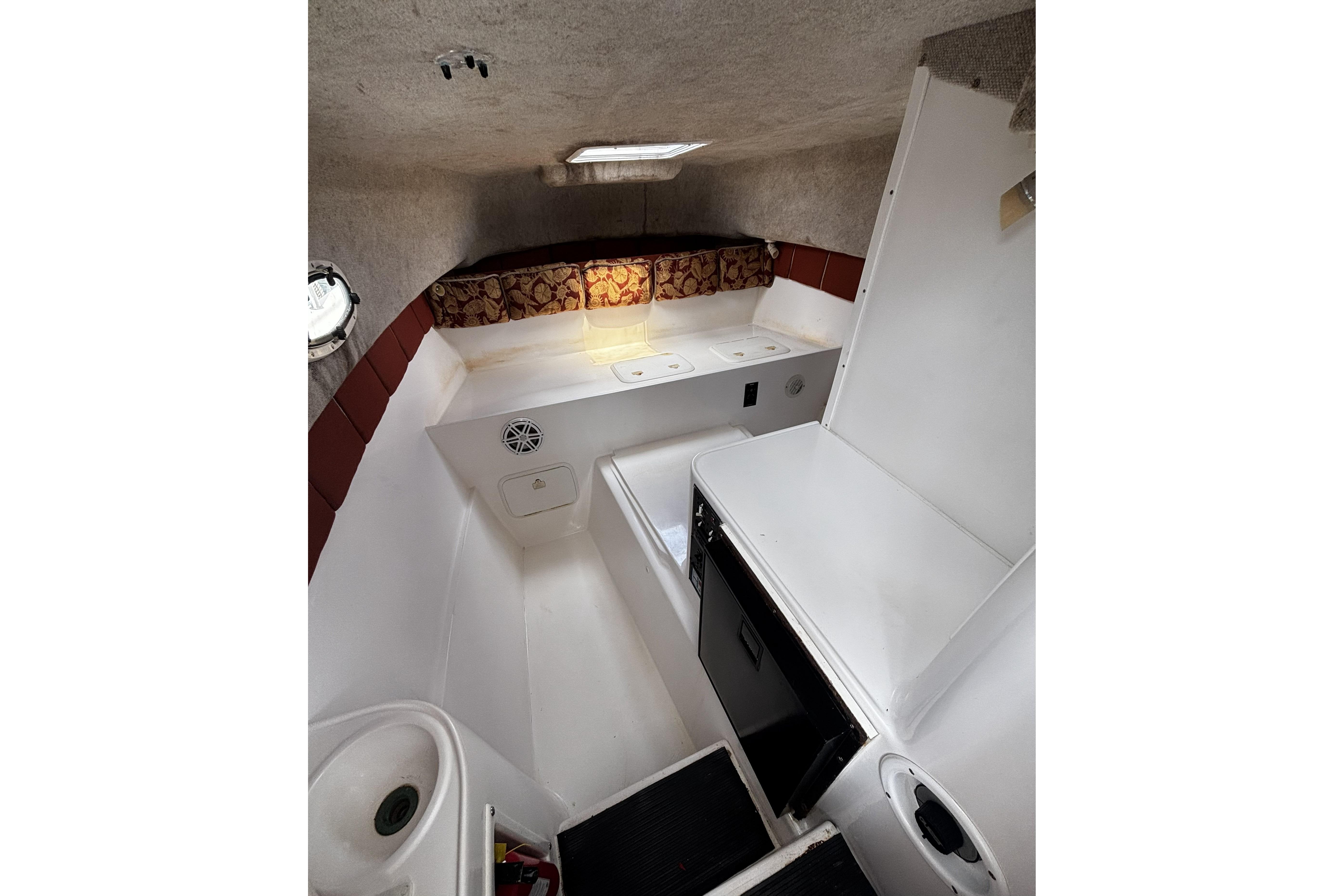 Interior cabin of 2005 Prosports 2860 KATWA boat with seating and storage.