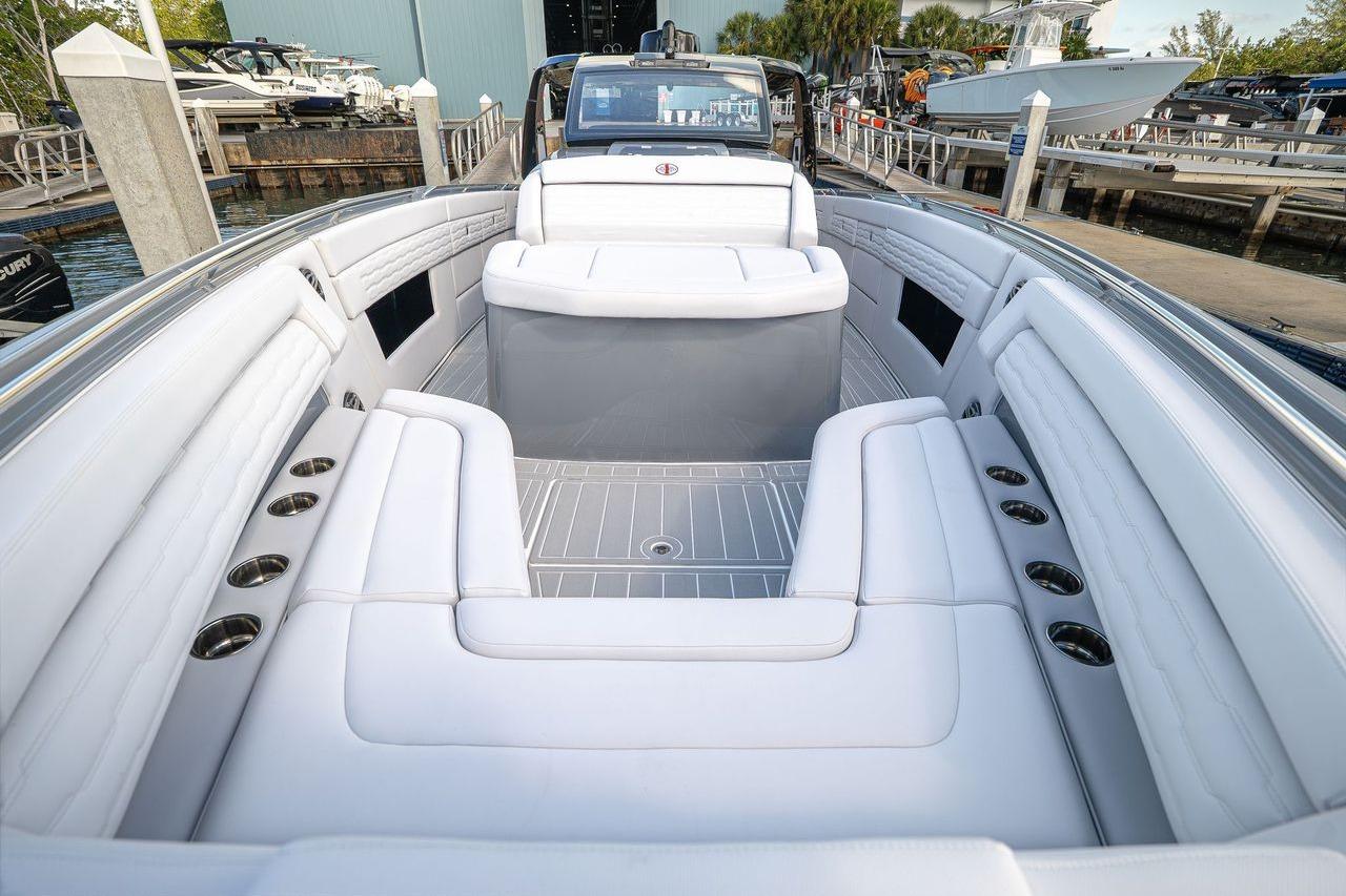 2026 Cigarette 42' Auroris luxury boat interior with white seating and cup holders.