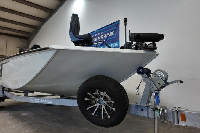 2024 Lowe Stinger 188 boat on trailer in indoor showroom setting.