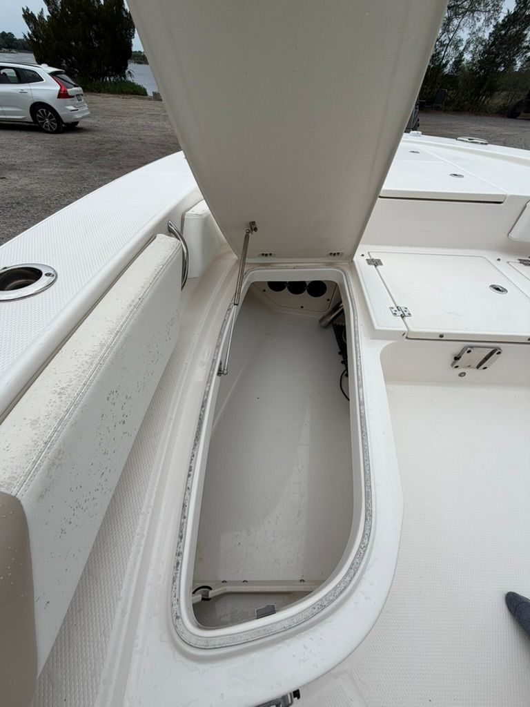 Open storage compartment on a 2018 Robalo 246 Cayman SD boat.