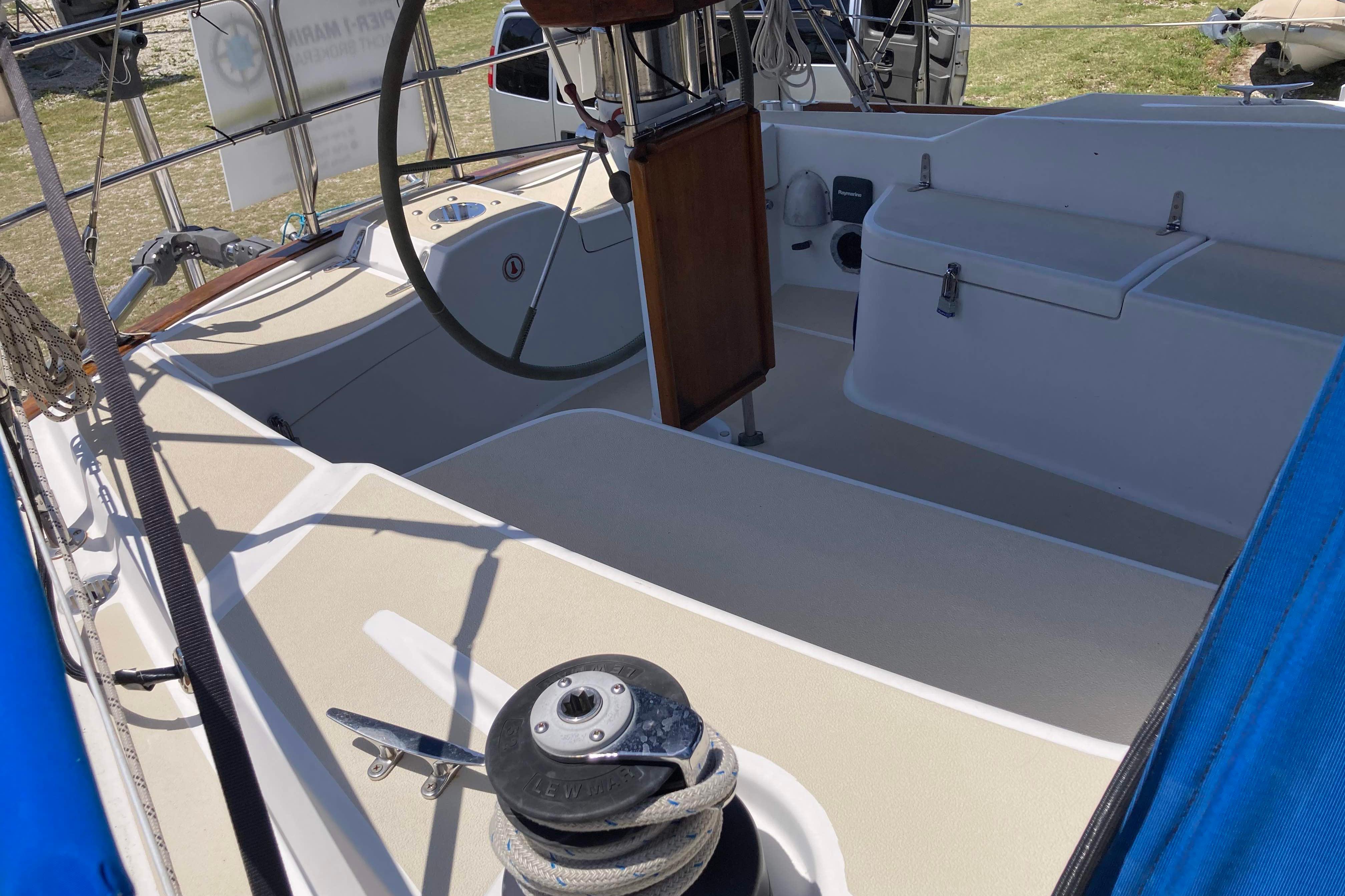 1990 Tartan 372 sailboat cockpit with steering wheel and winch.