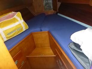Interior of a 1968 Hinckley Pilot 35 yacht with blue cushions.