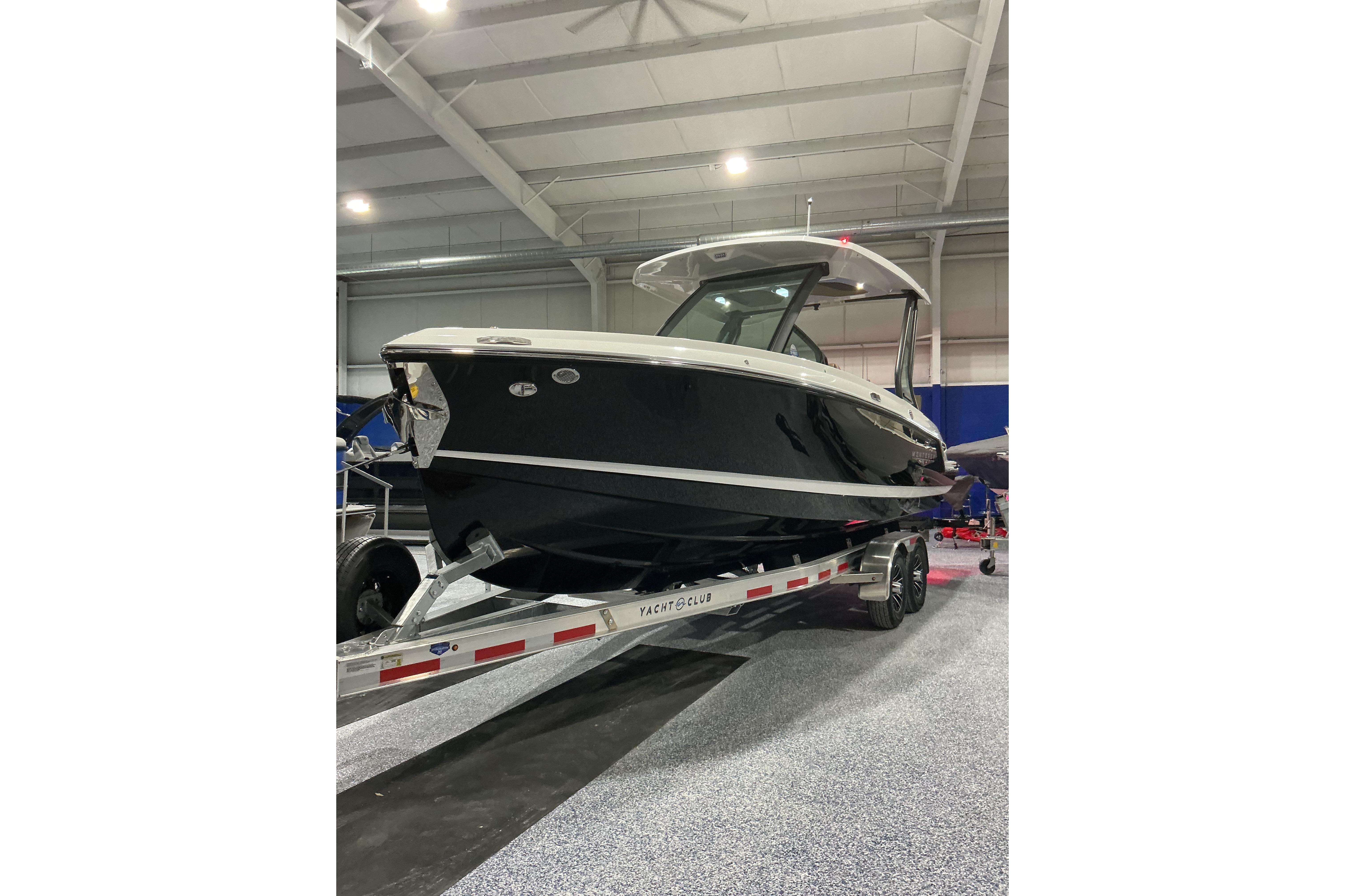 2026 Monterey Elite 25 SD boat on trailer in indoor showroom.