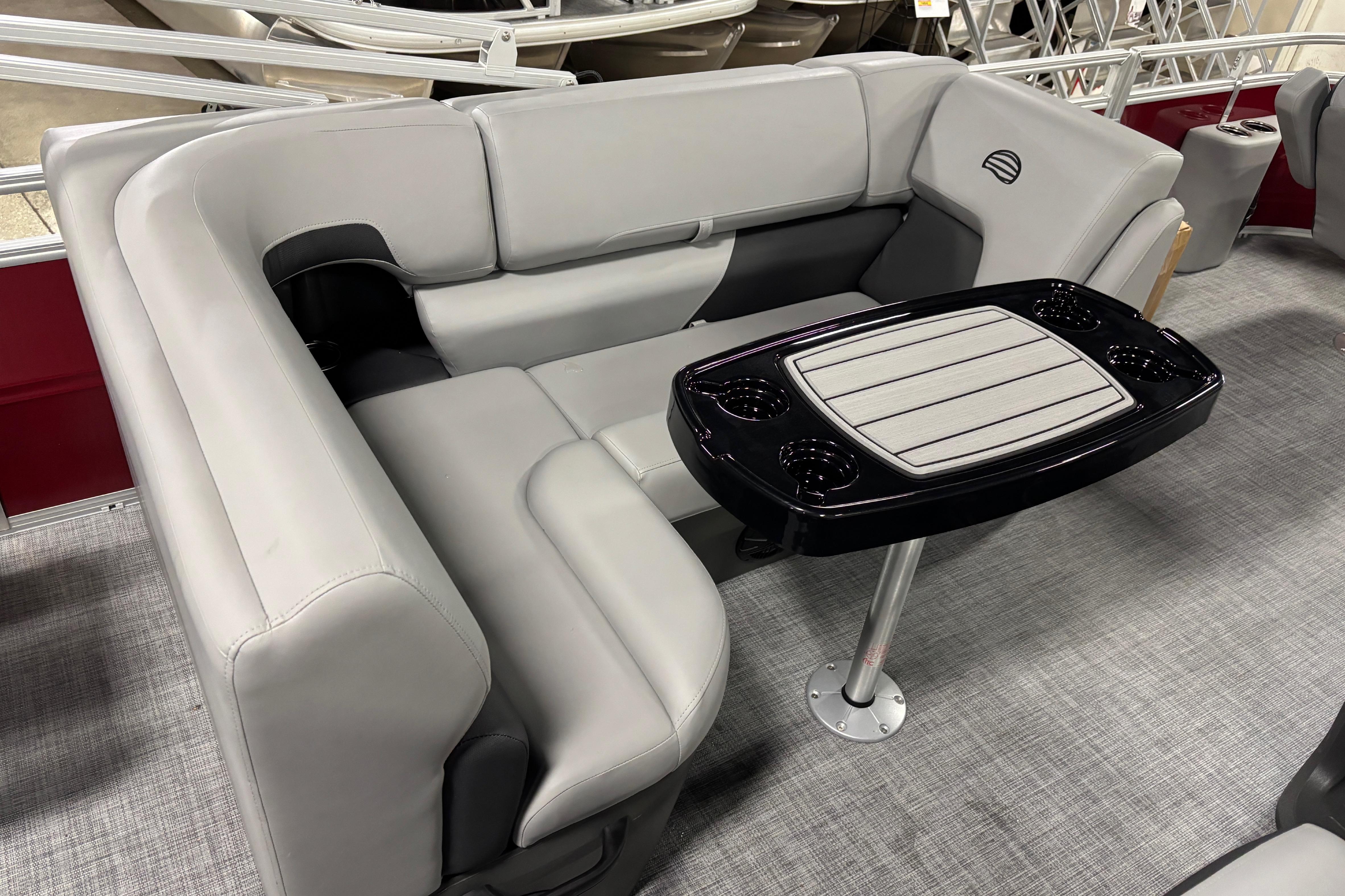 2026 Sun Tracker SportFish 20 DLX boat interior with gray seating and a central table.