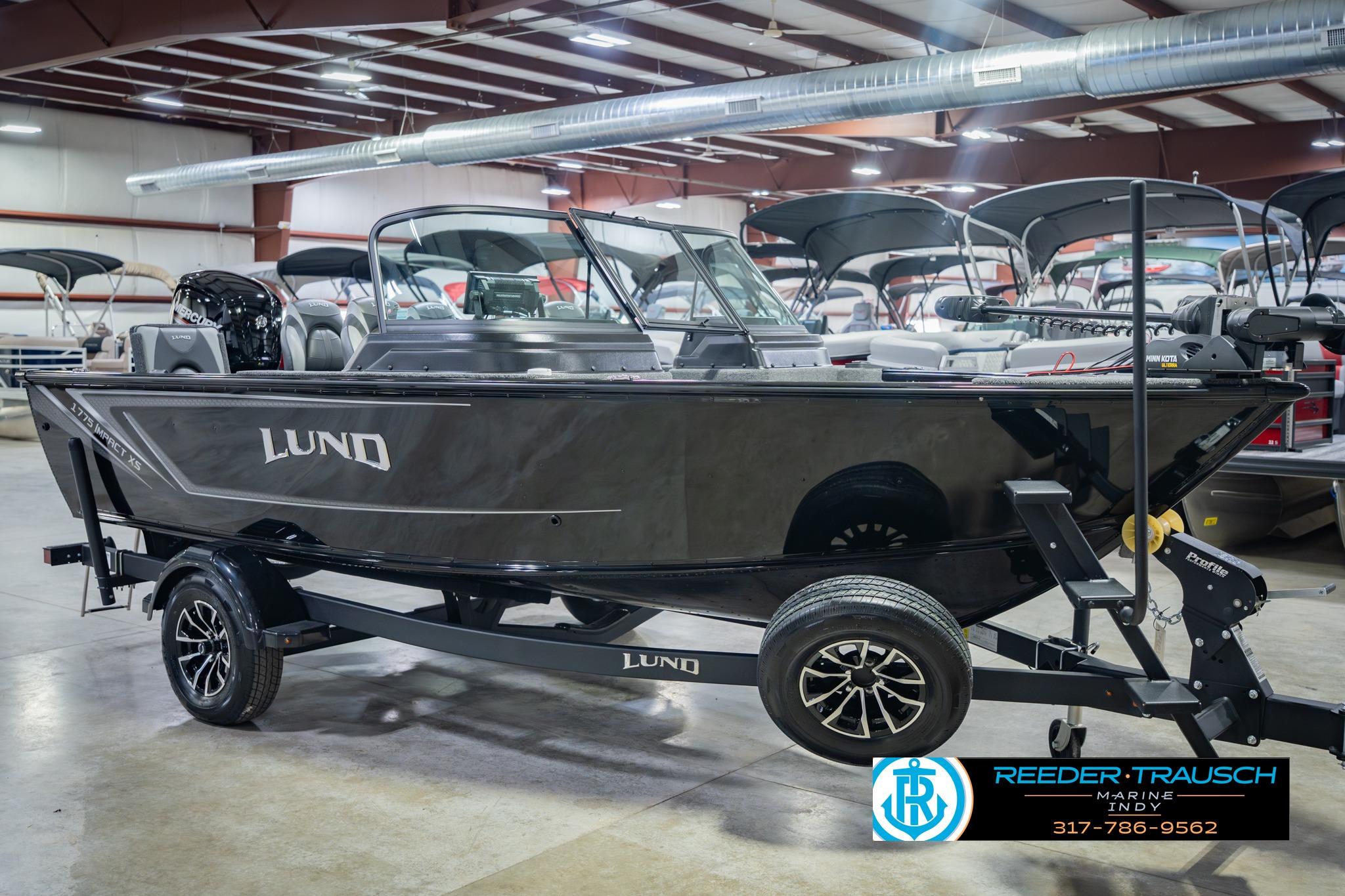 2026 Lund 1775 Impact XS boat displayed indoors on a trailer.
