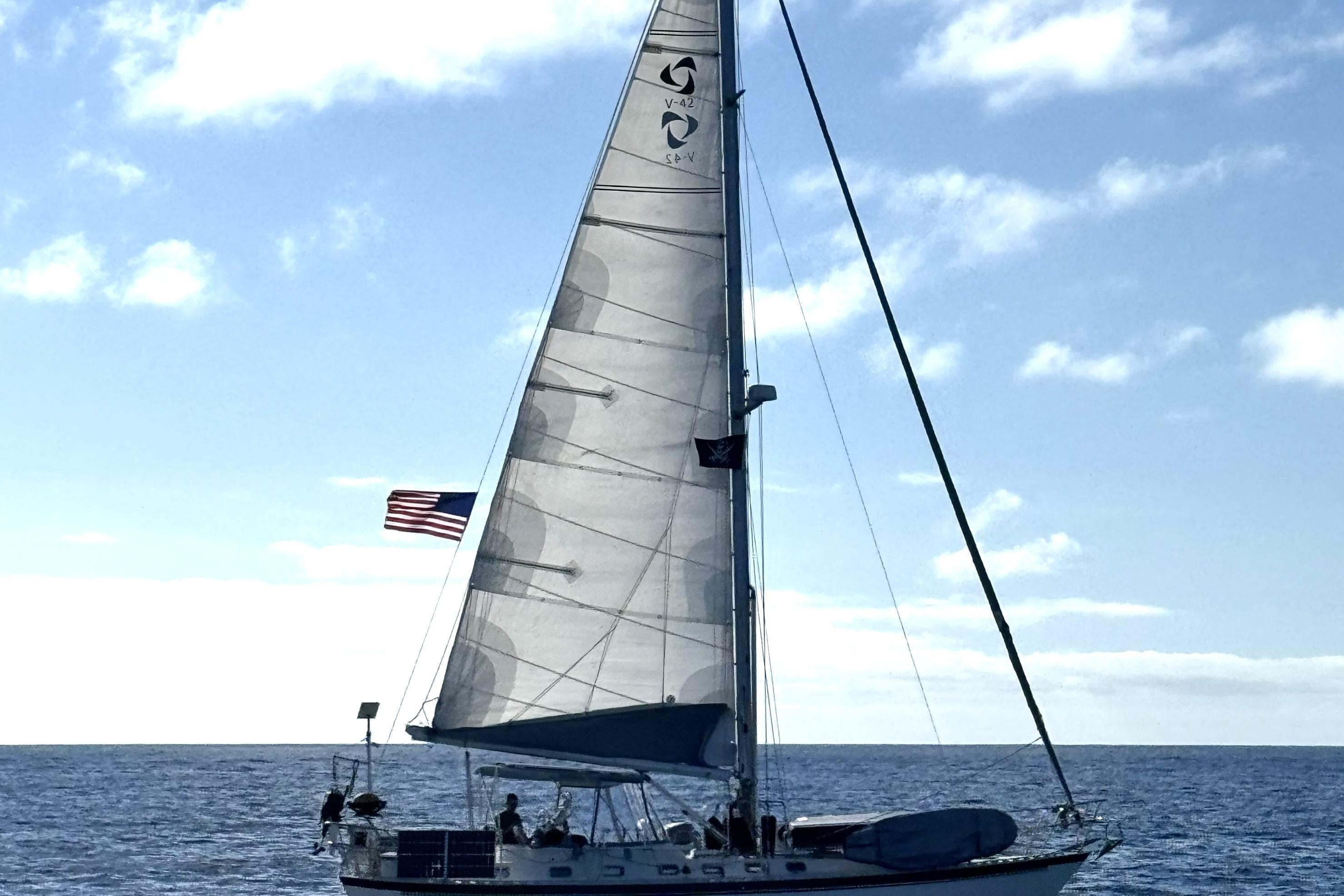 Sailing yacht Tayana Vancouver 42, 2001 model, on open sea under clear skies.