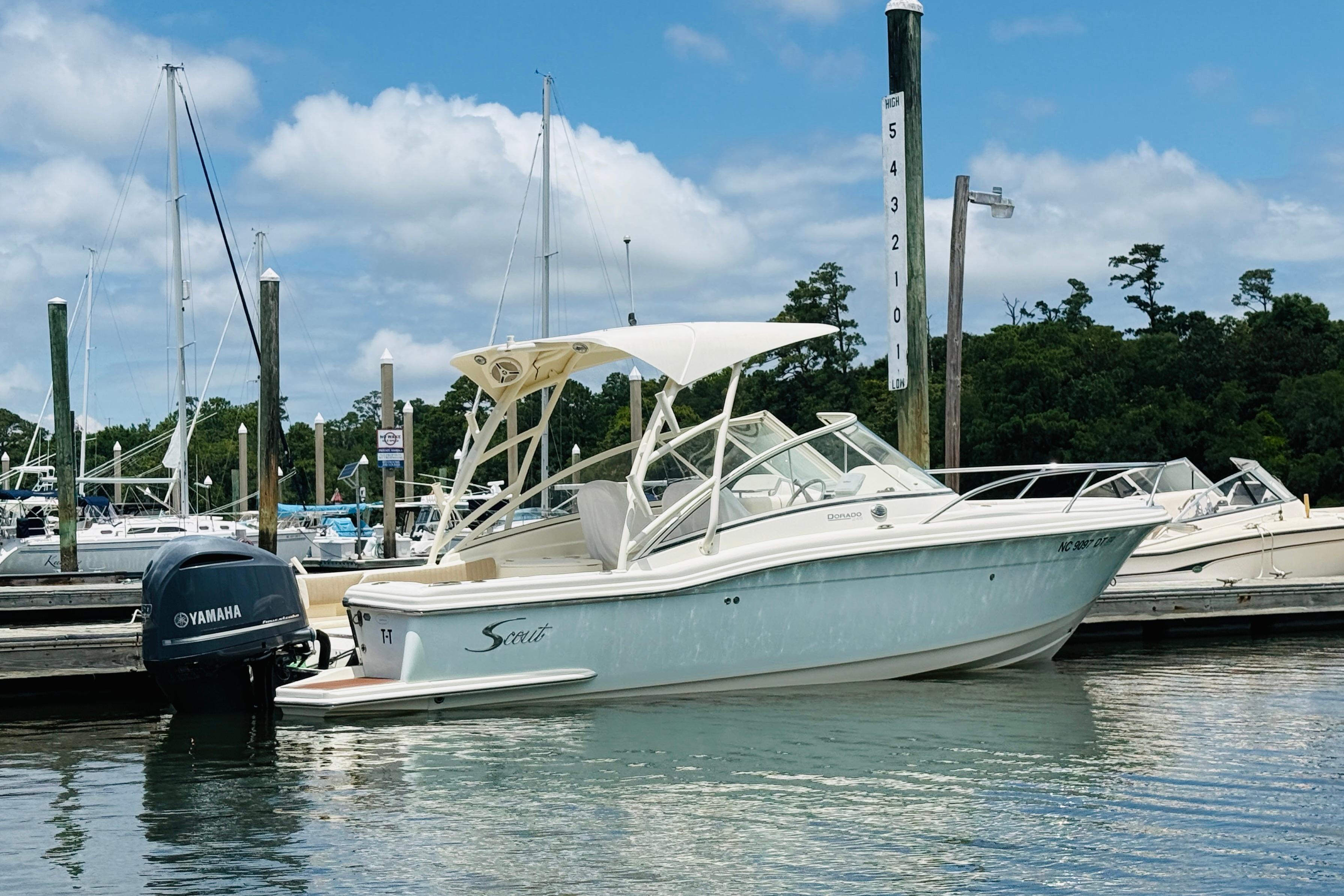 2012 Scout 245 Dorado boat docked with Yamaha outboard motor, under clear blue sky.