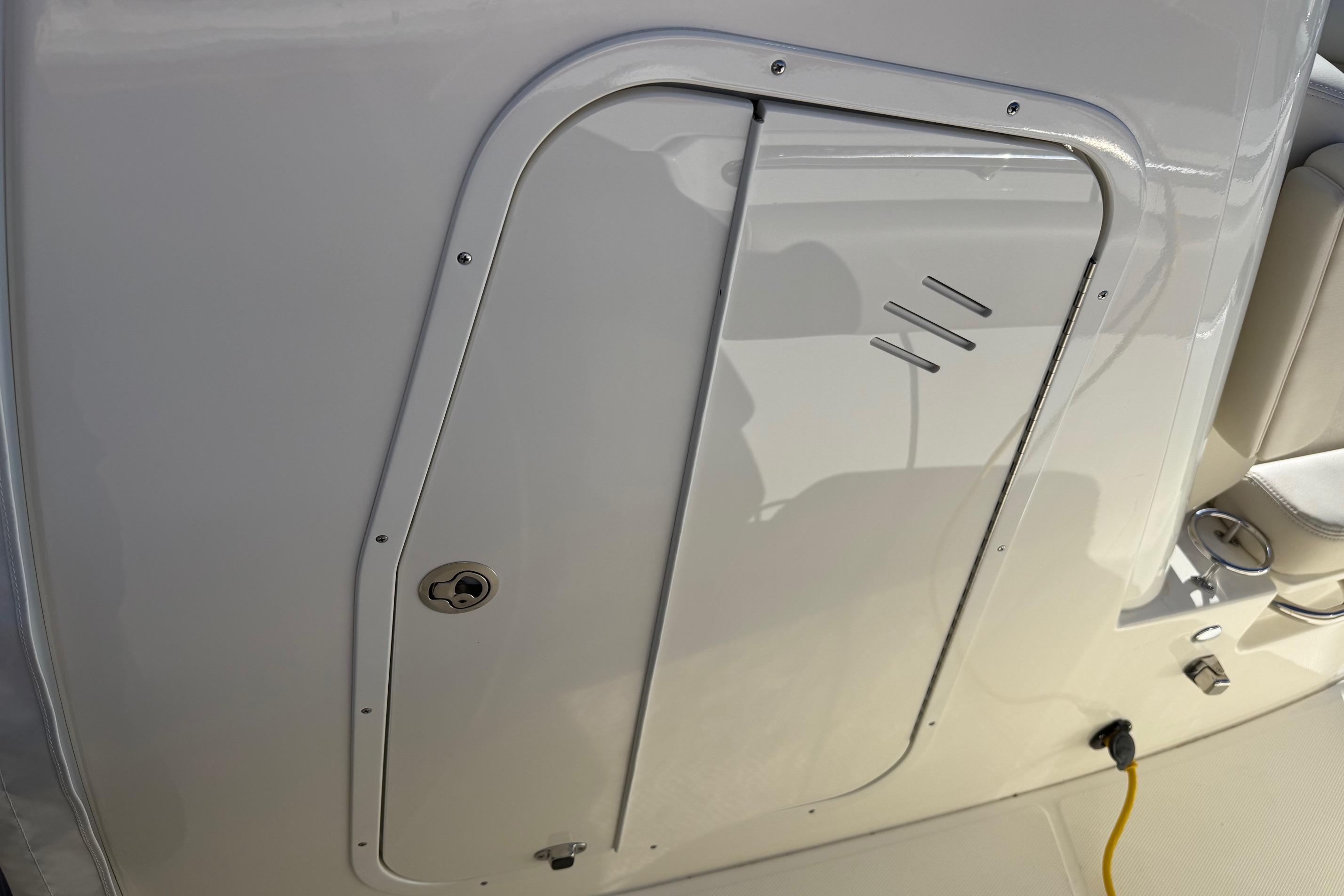 2025 Boston Whaler 250 Outrage boat interior, featuring a sleek storage compartment door.
