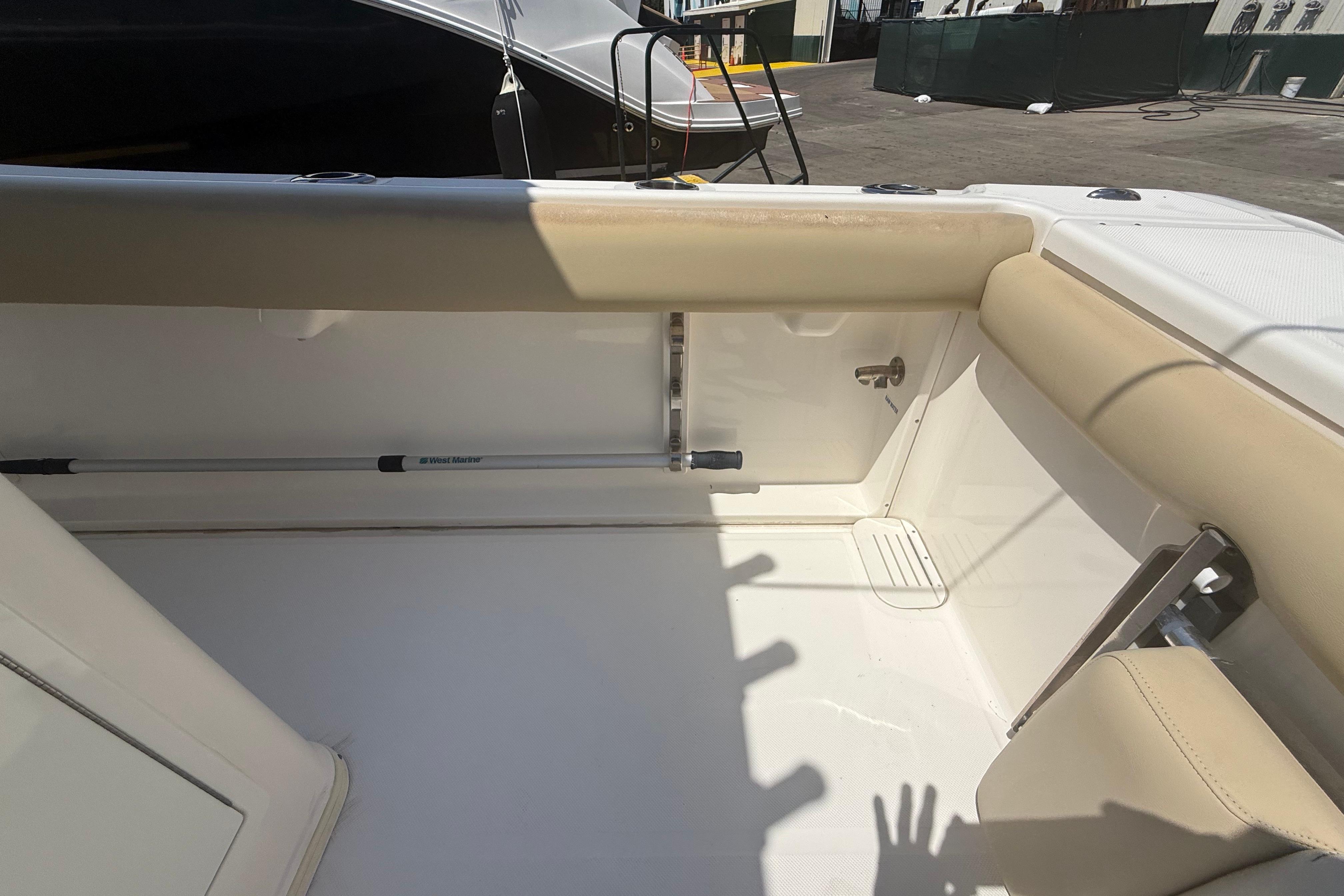 2019 Key West Billistic 281 Center Console interior with beige seating and storage area.