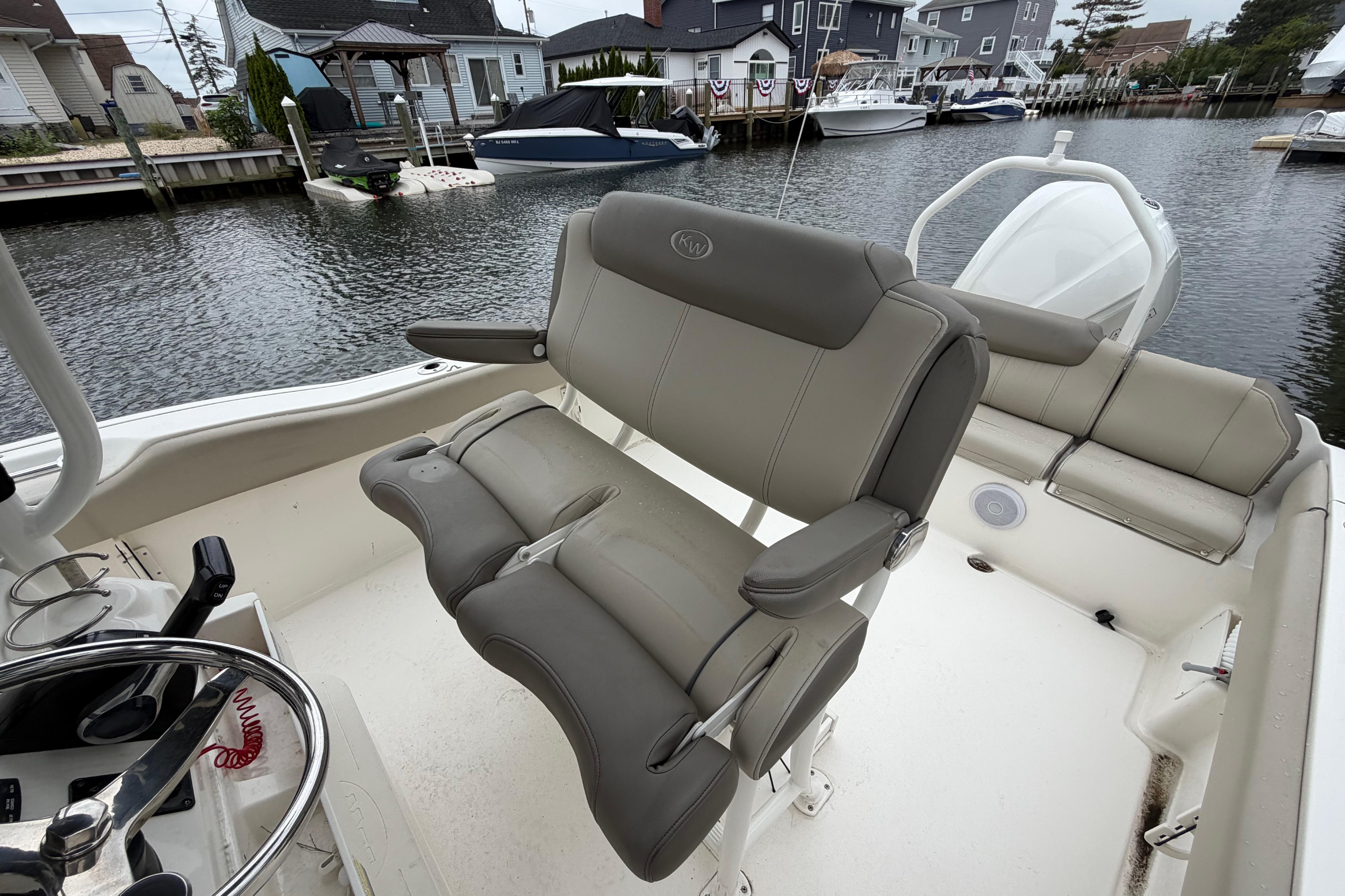 2022 Key West 239 FS boat interior with comfortable seating and steering wheel.