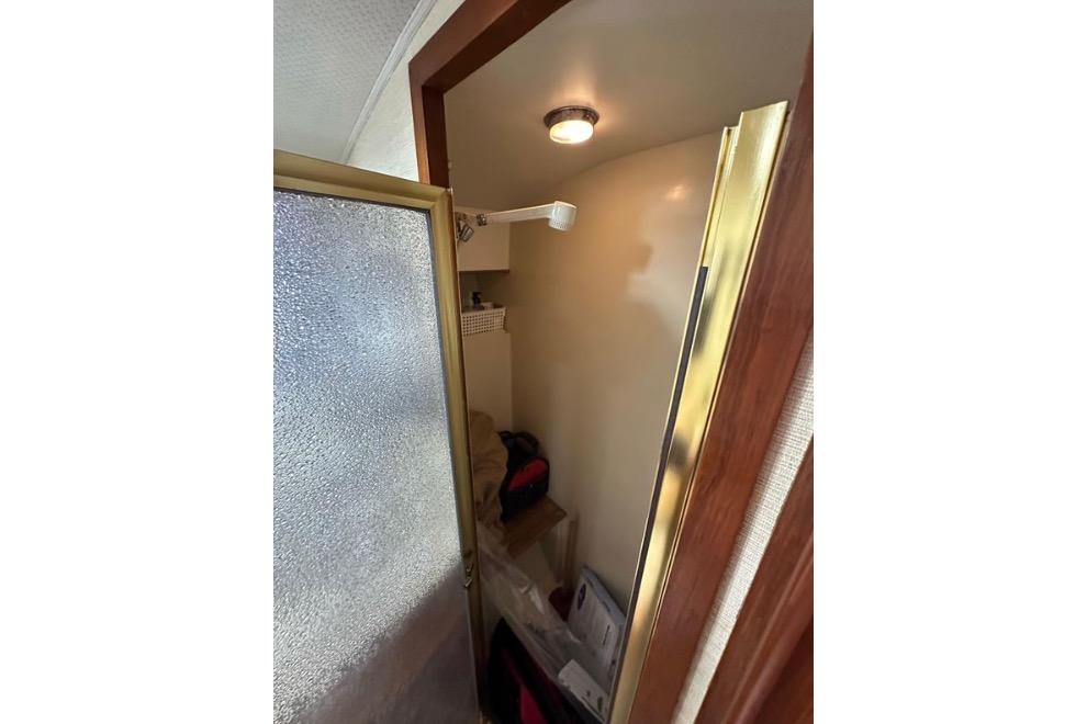 Interior of 1985 Egg Harbor 33 Sedan boat showing a compact shower area.