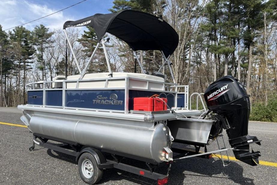 2026 Sun Tracker Bass Buggy 16 XL Select pontoon boat with Mercury outboard motor on trailer.