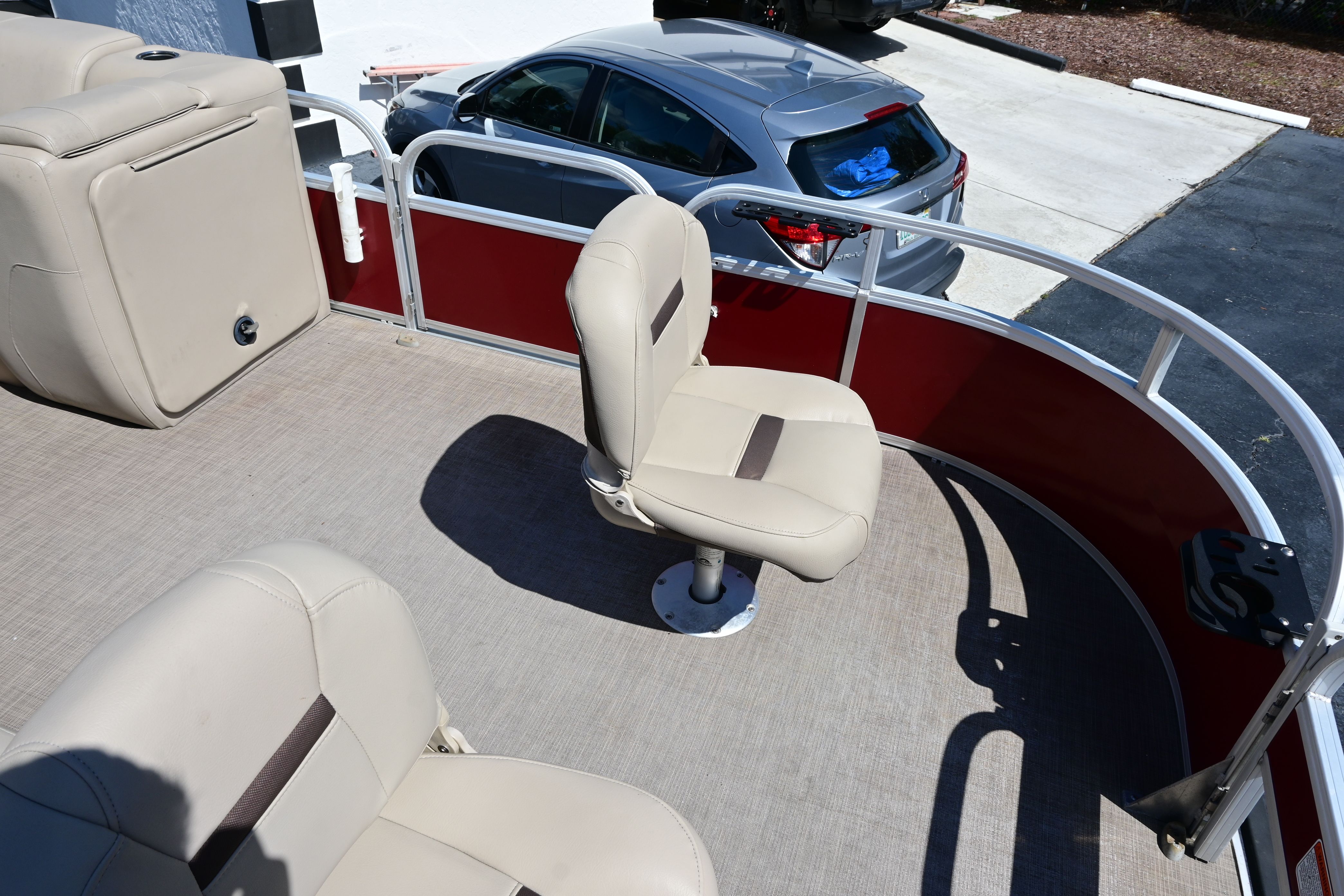 Interior of a 2019 Sun Tracker FISHI pontoon boat with beige seats.