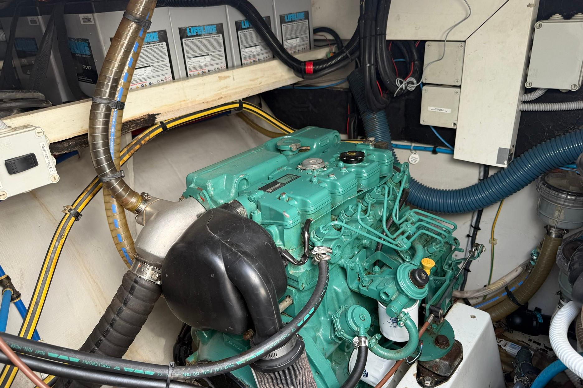 Engine room of 2008 Fountaine Pajot Salina 48 catamaran with visible machinery and wiring.