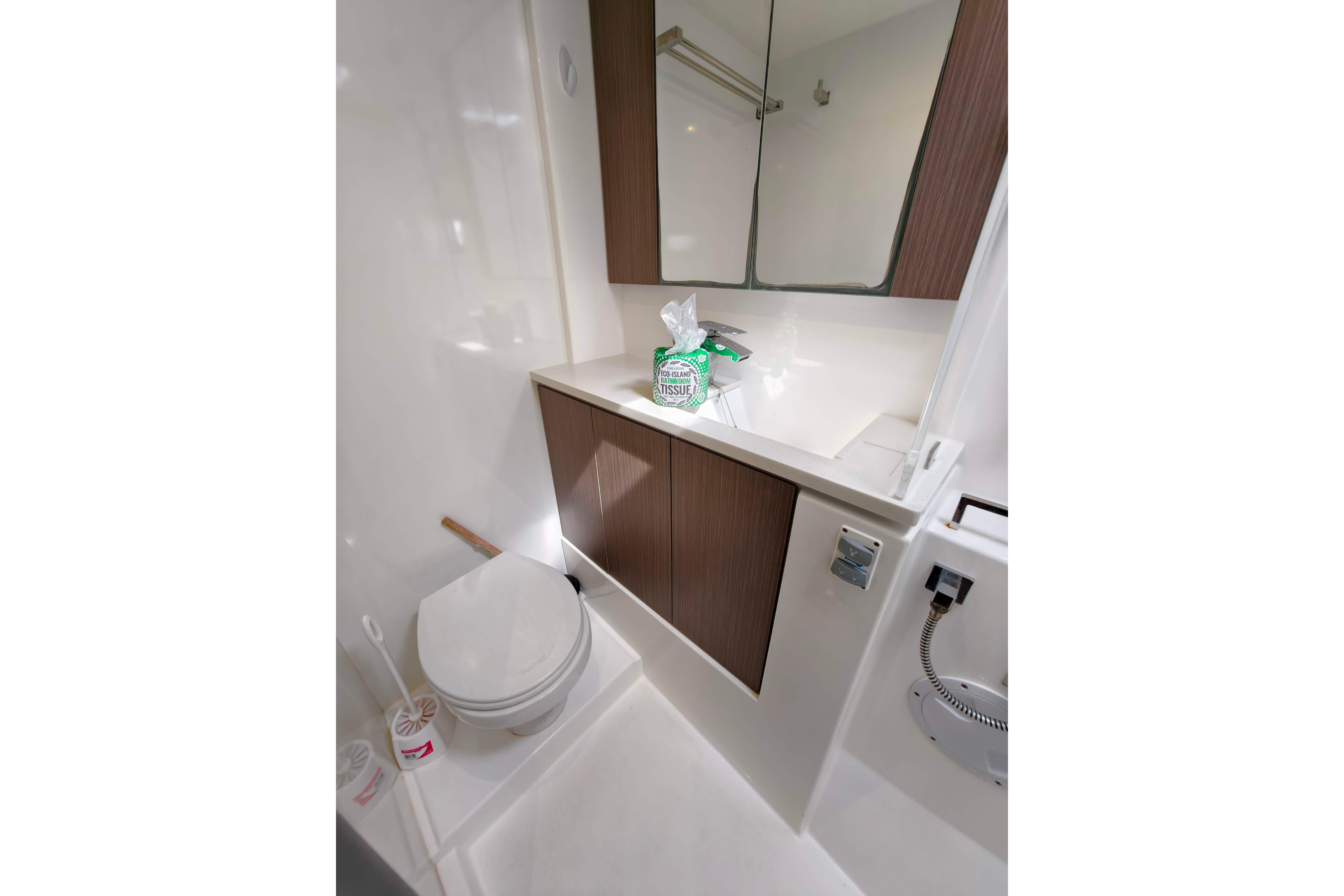 Modern bathroom in 2022 Leopard 45 yacht with sleek design and wood accents.