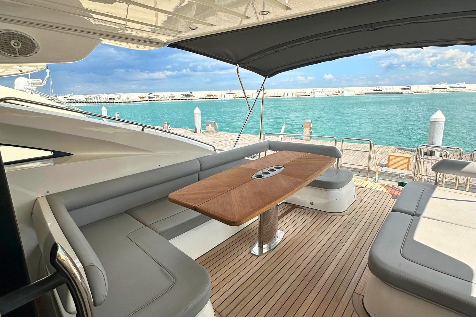 Luxurious 2009 Princess V65 yacht deck with elegant seating and ocean view.
