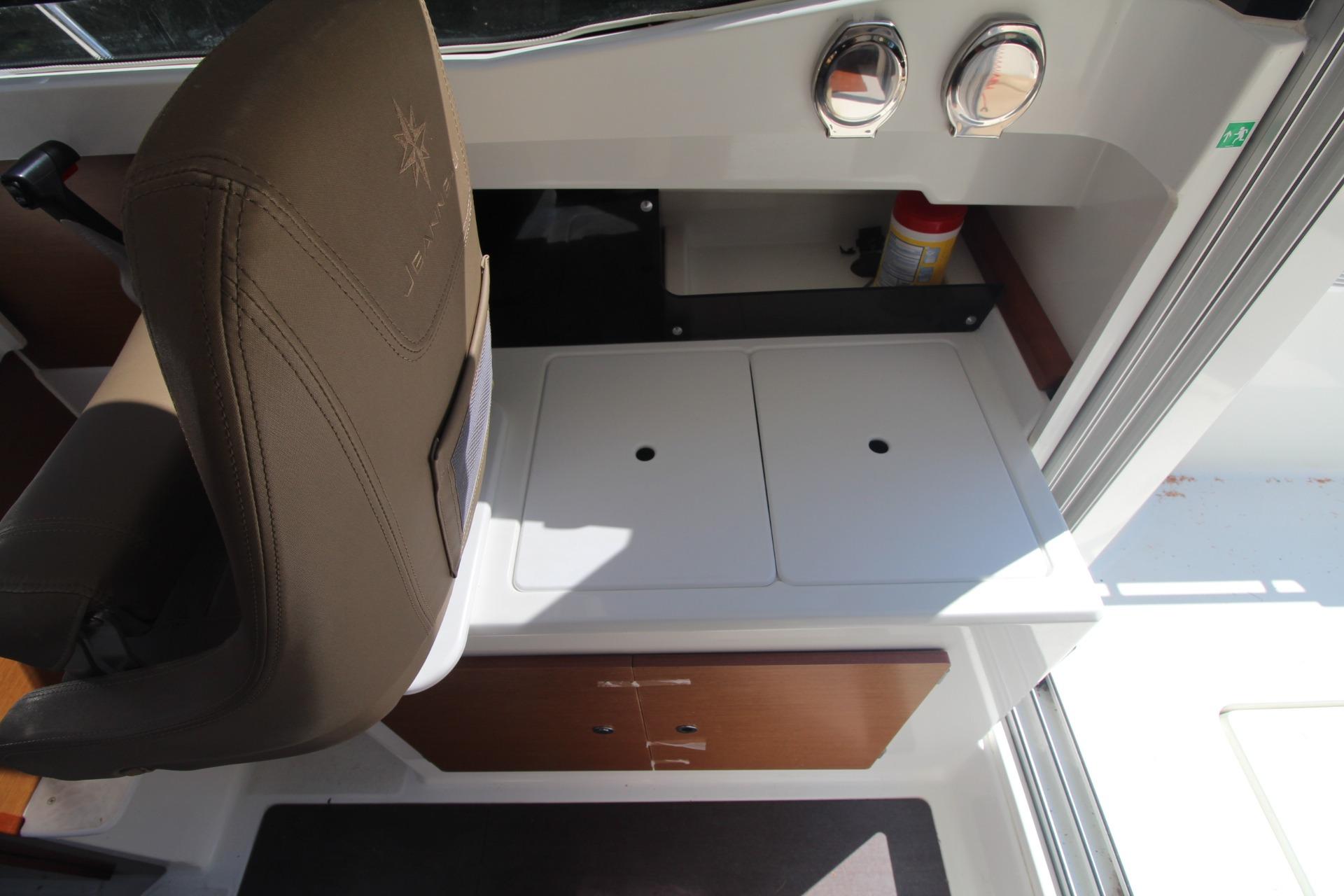 Interior of 2017 Jeanneau NC Sport 695 boat with seating and storage area.