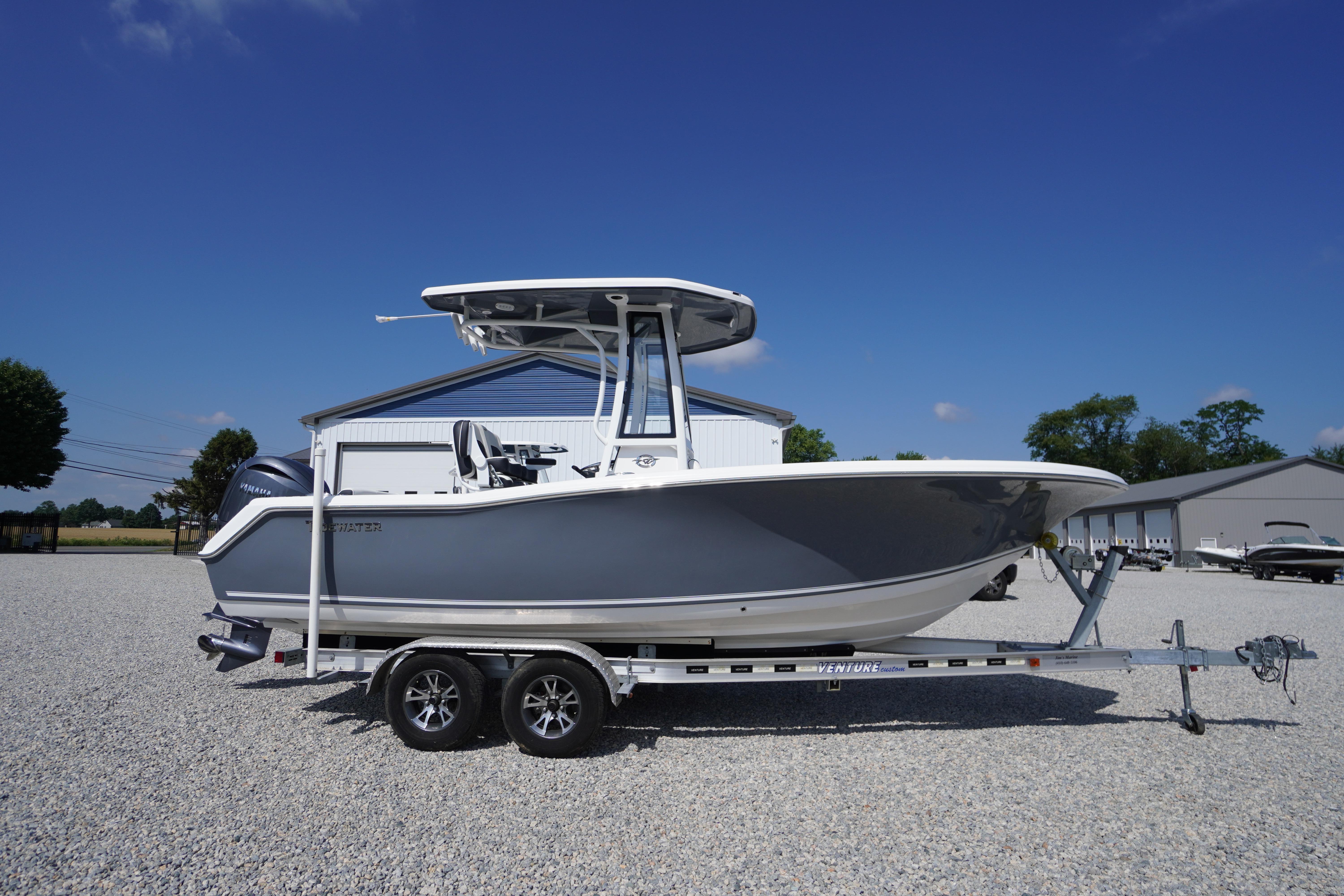 2026 Tidewater 220 CC Adventure boat on trailer under clear blue sky.