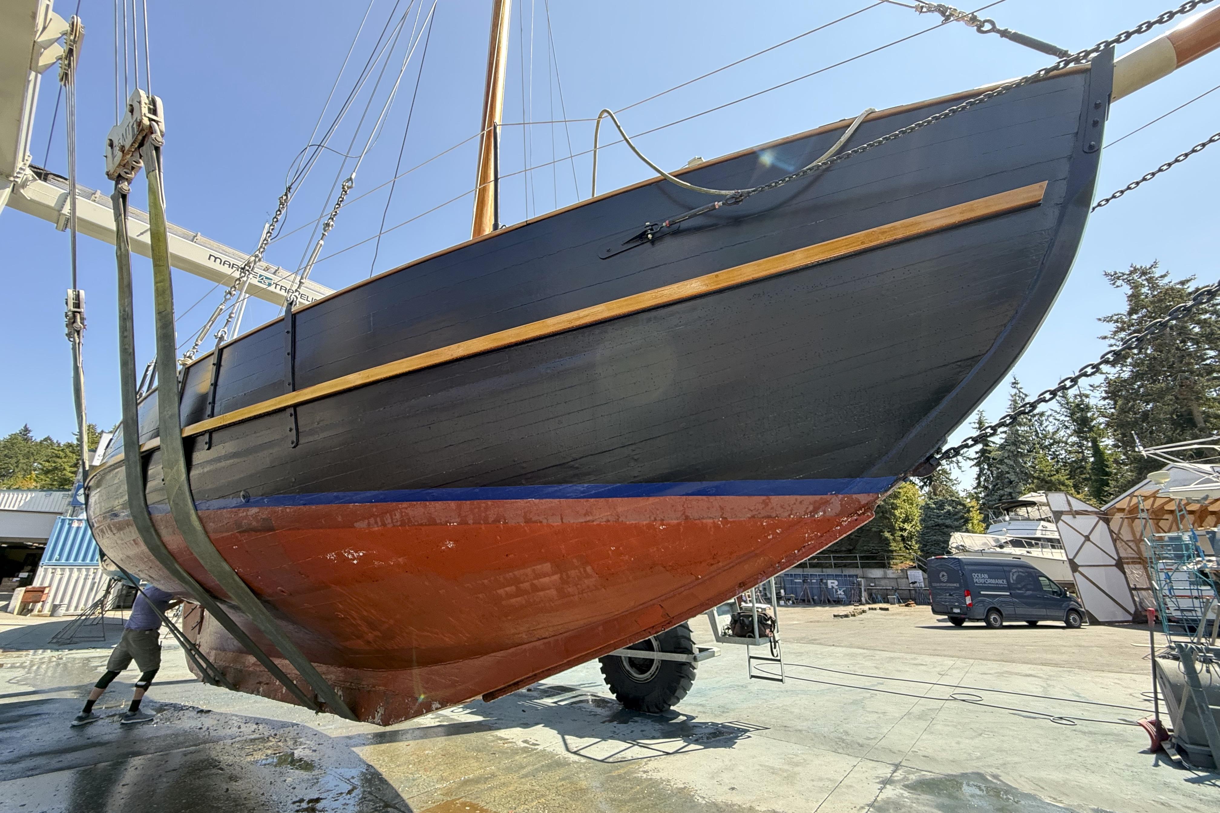Vintage 1965 William Hand 45 sailboat being lifted in a shipyard.