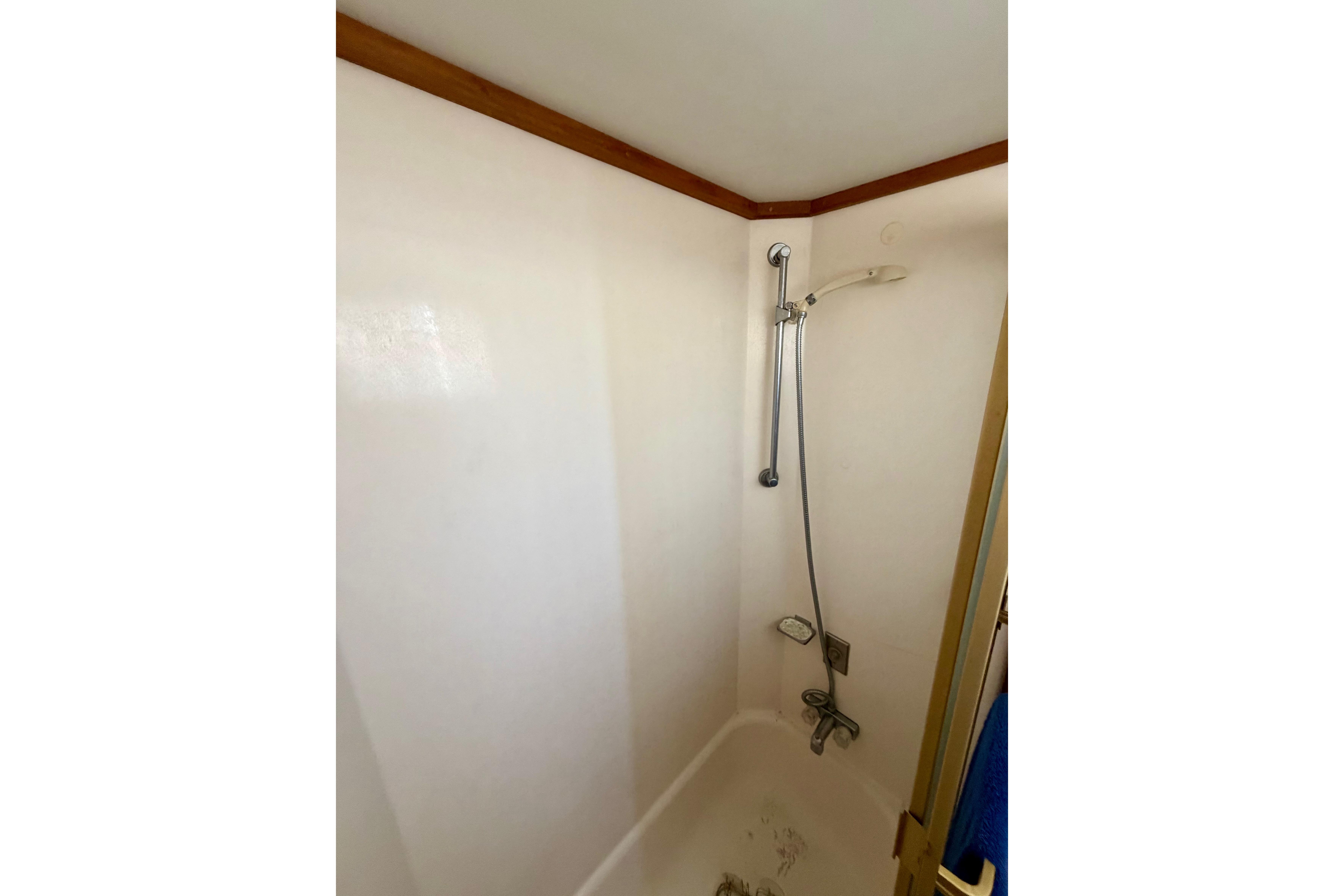 Shower area in 1978 Californian 38 LRC boat with handheld showerhead.