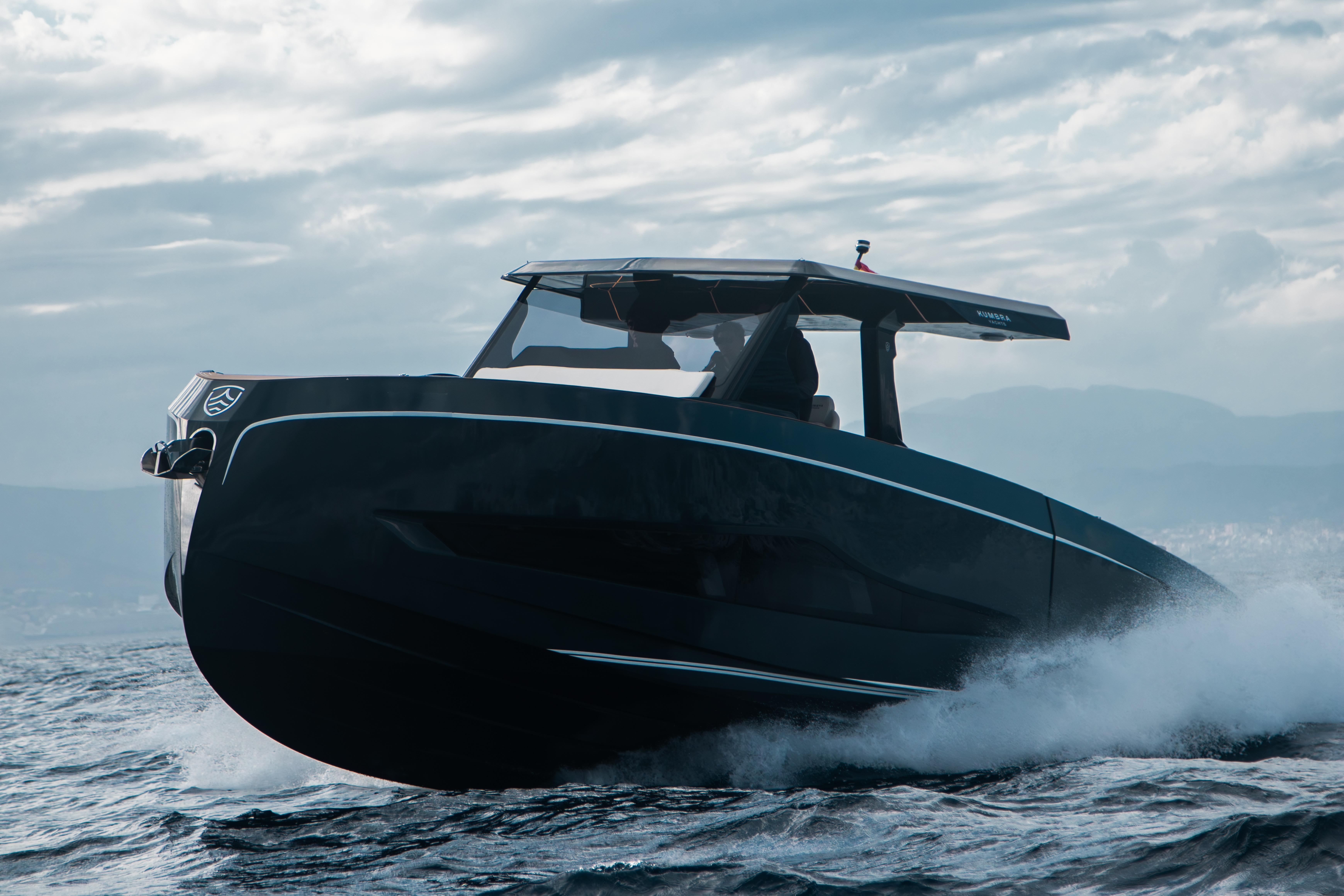 Modern Kumbra 43 boat cruising through waves, 2026 model, under a cloudy sky.