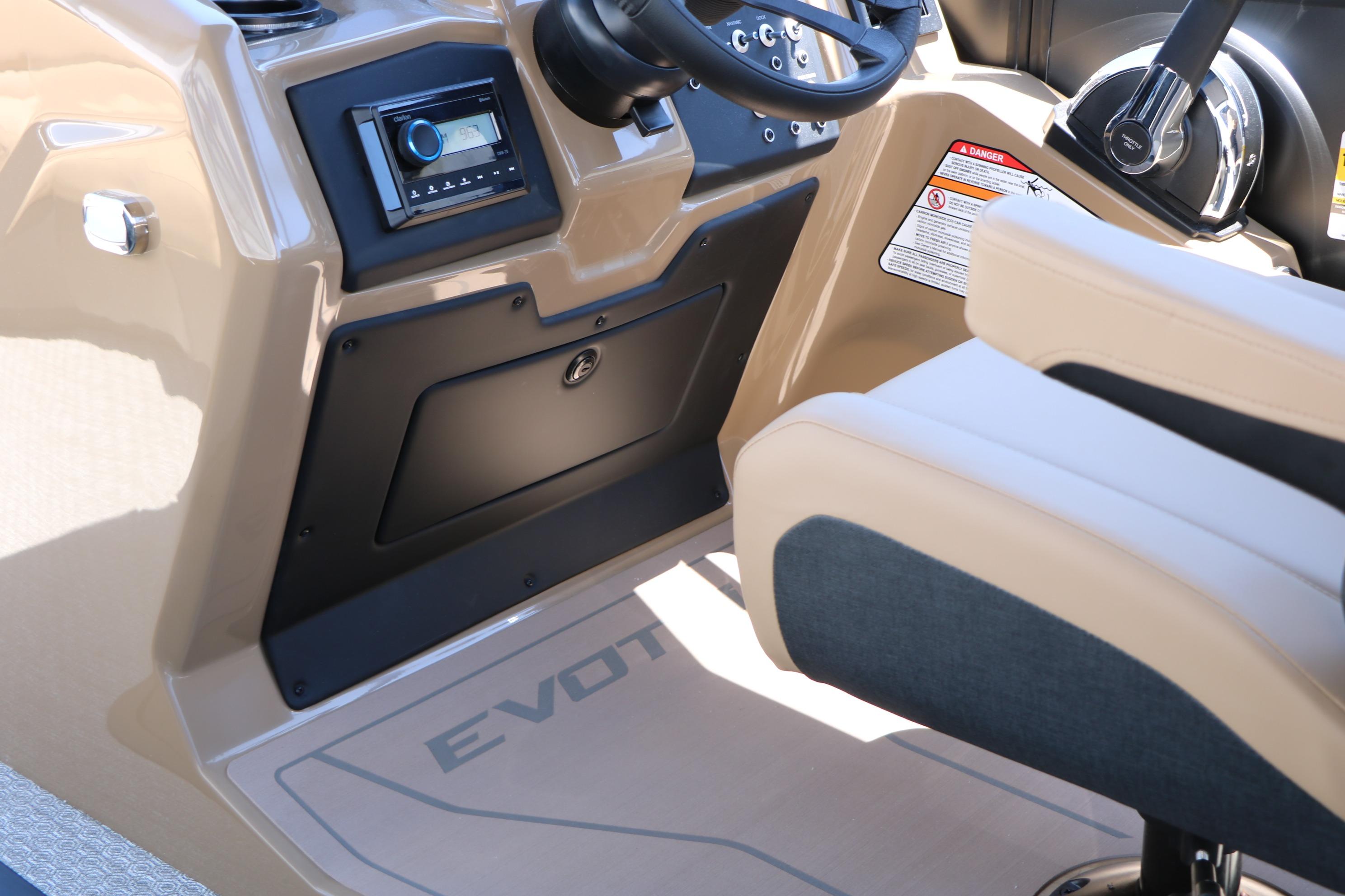Interior of 2026 Evotti 521CS boat, featuring steering console and beige seating.
