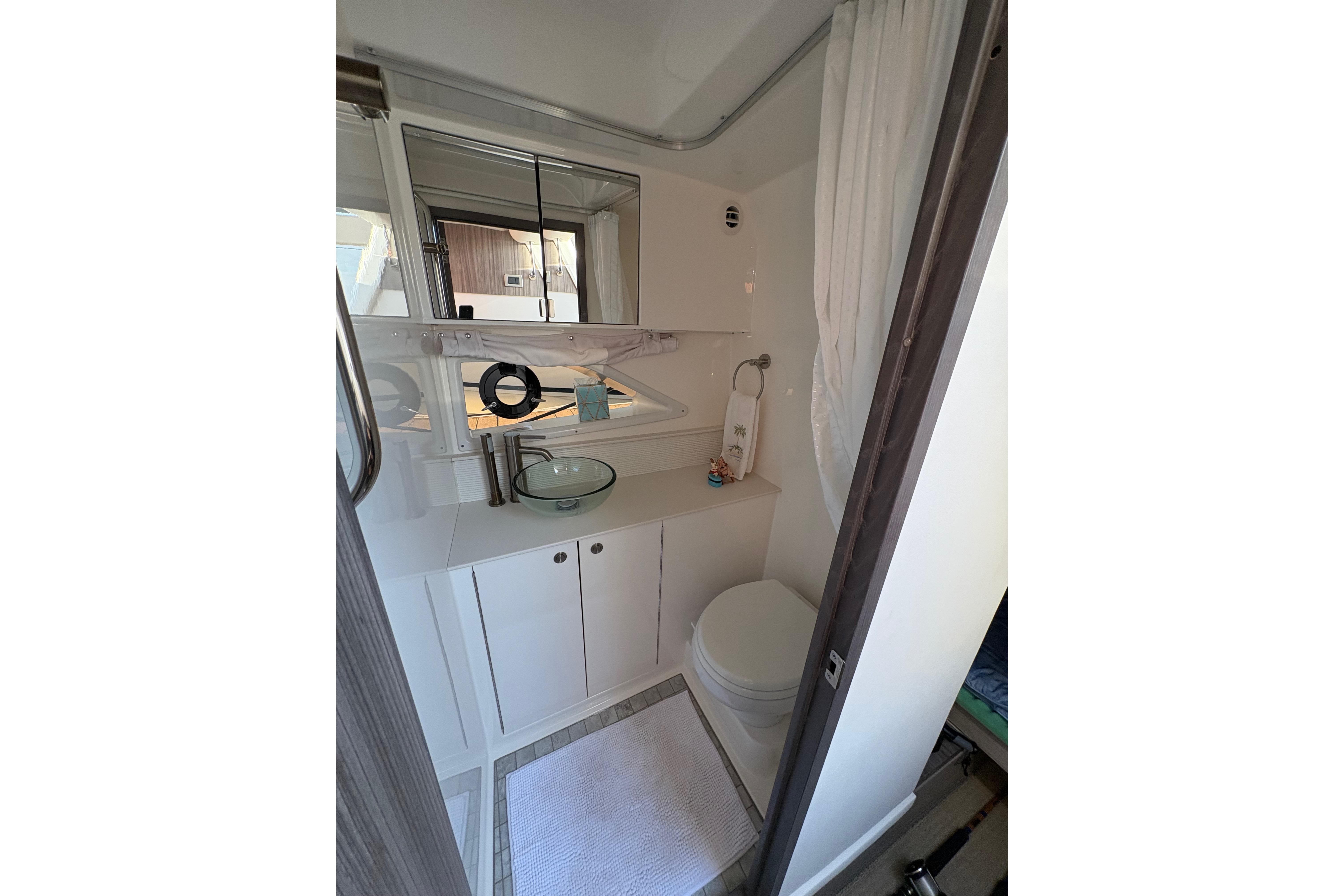 2022 Sea Ray Sundancer 320 bathroom with modern fixtures and compact design.