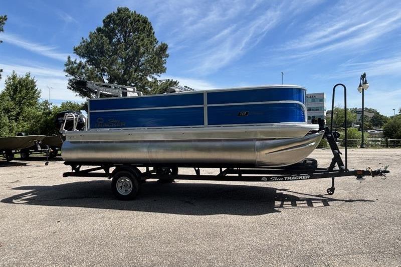 2026 Sun Tracker Party Barge 18 DLX pontoon boat on trailer, parked outdoors.