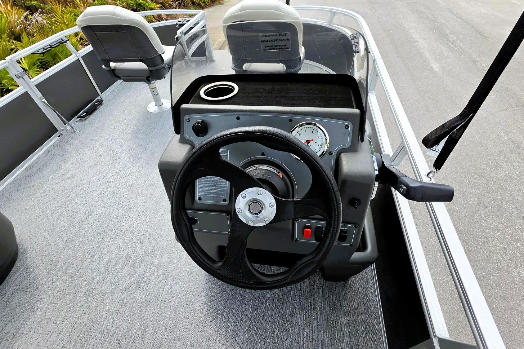 2026 Sun Tracker Bass Buggy 16 XL Select boat dashboard with steering wheel and gauges.