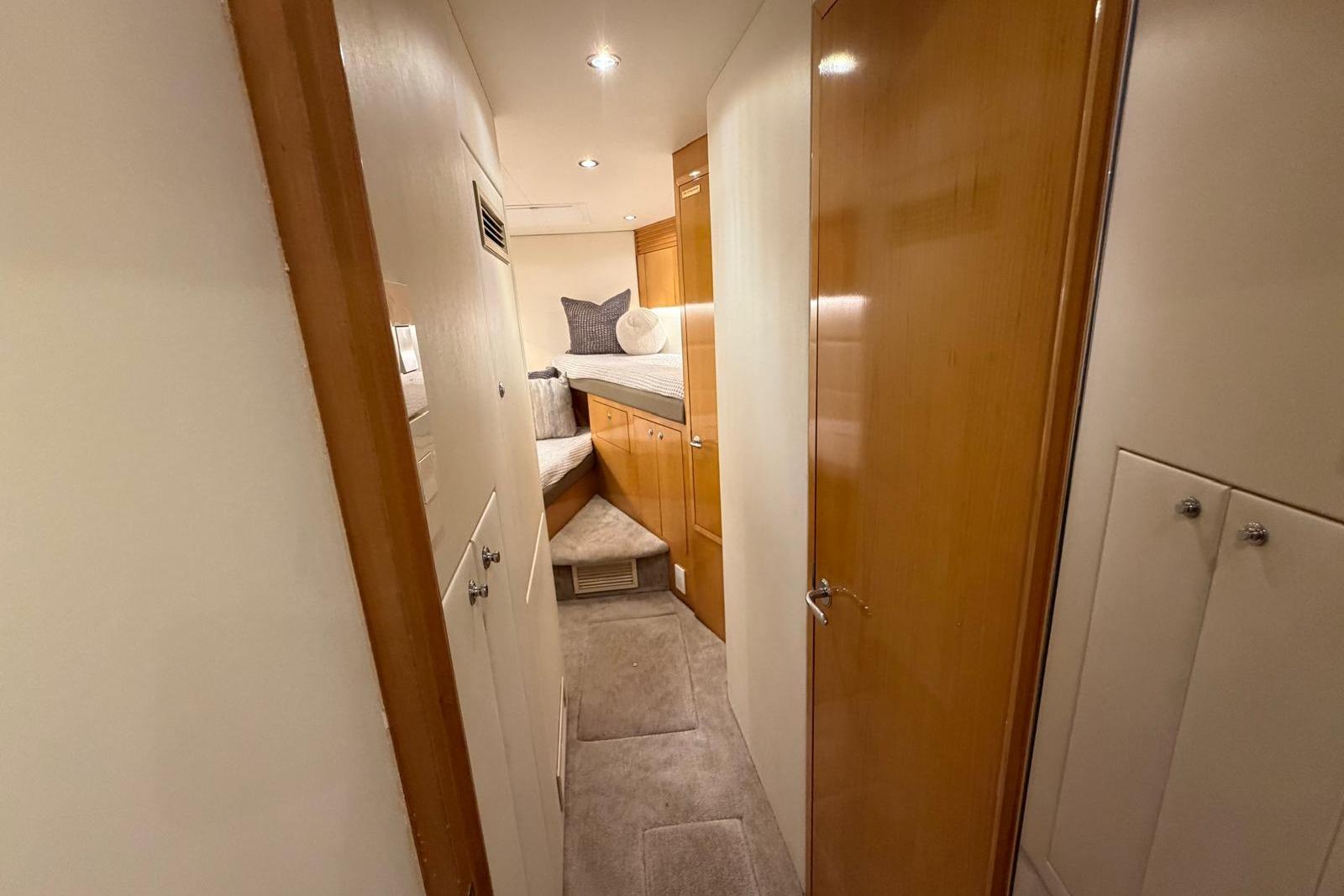 Interior hallway of 2003 Hatteras 54 Convertible yacht with cozy cabin view.