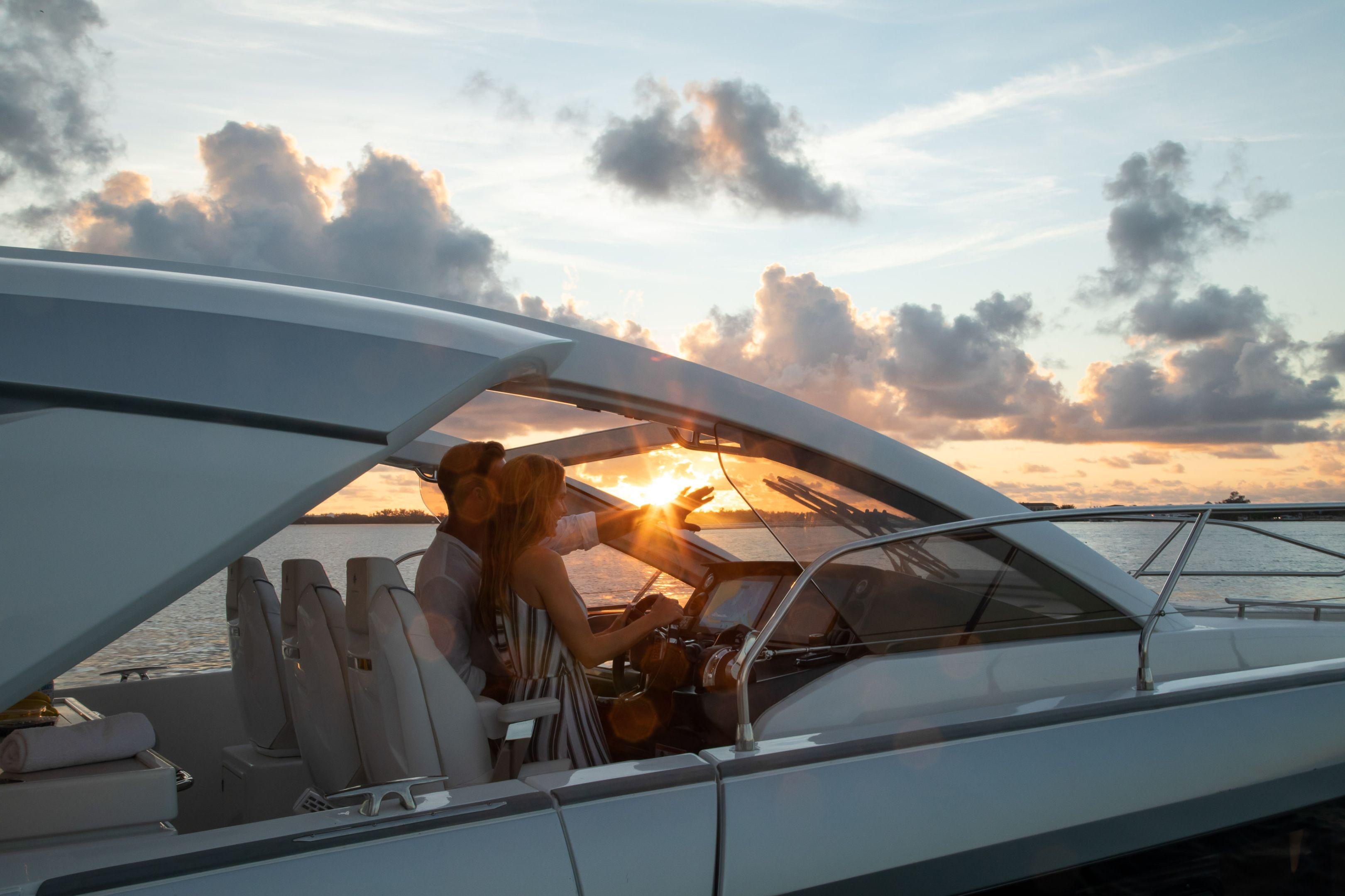 2025 Jeanneau DB/43 OB yacht cruising at sunset with passengers enjoying the view.