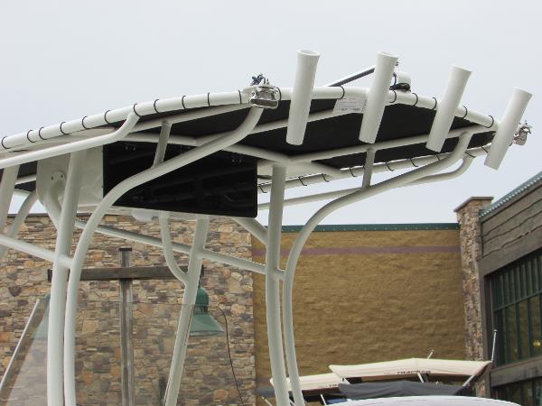 2023 Mako 214 CC boat with rod holders and T-top.