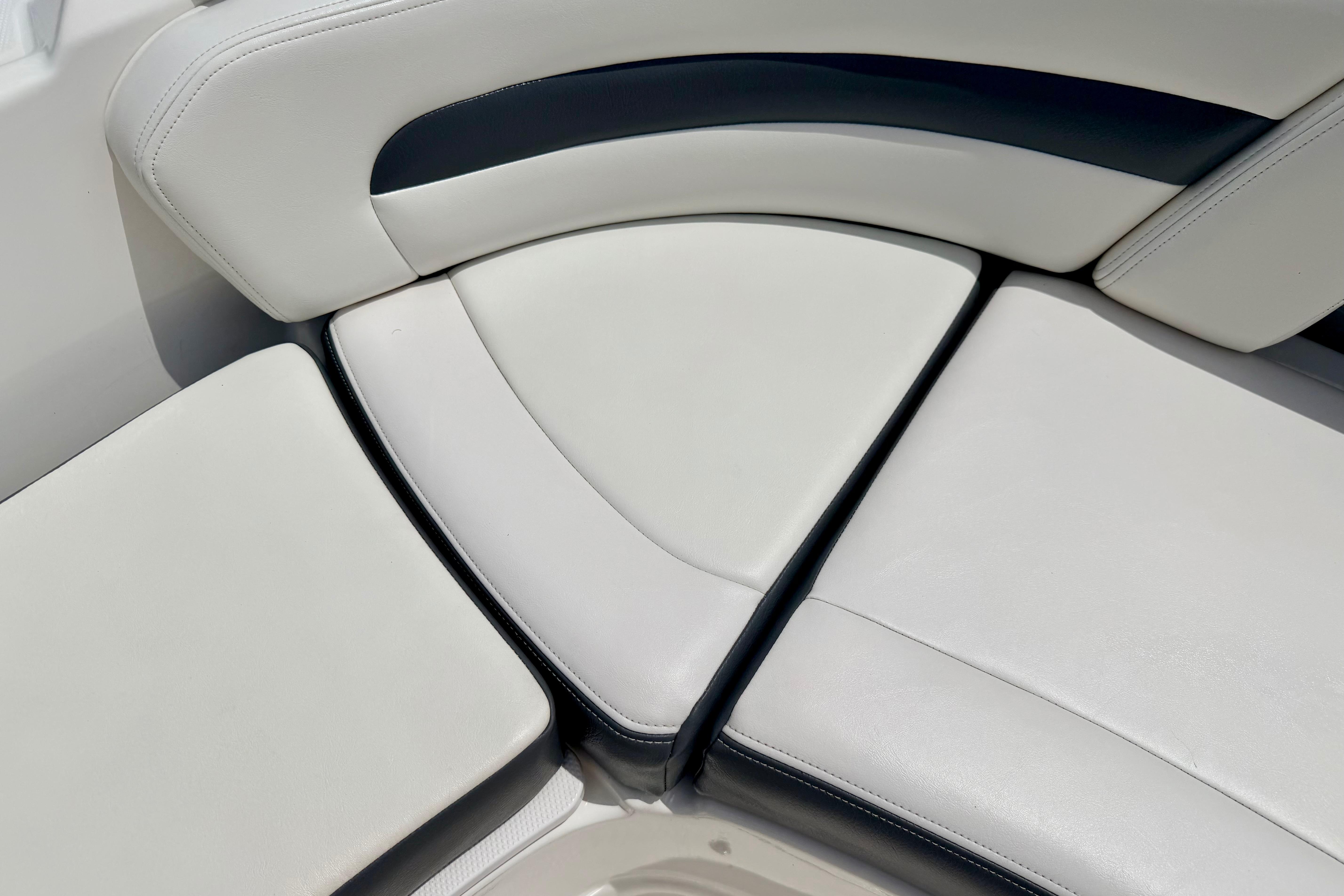 2015 Chaparral Sunesta 264 boat seating with white and black upholstery.
