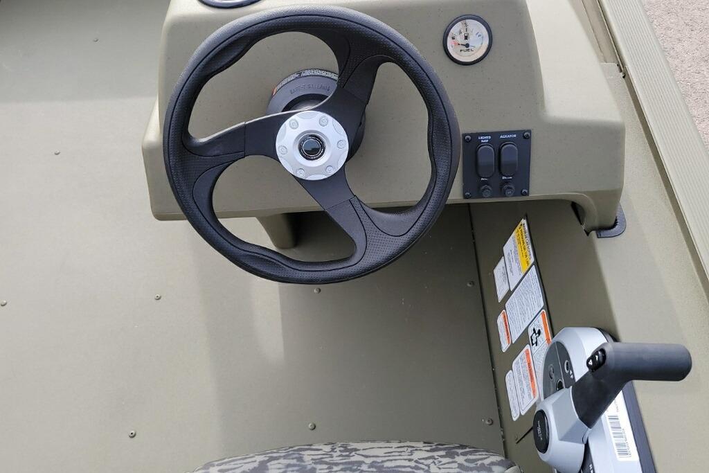 Steering console of 2026 Tracker Grizzly 1754 SC boat with controls and gauges.