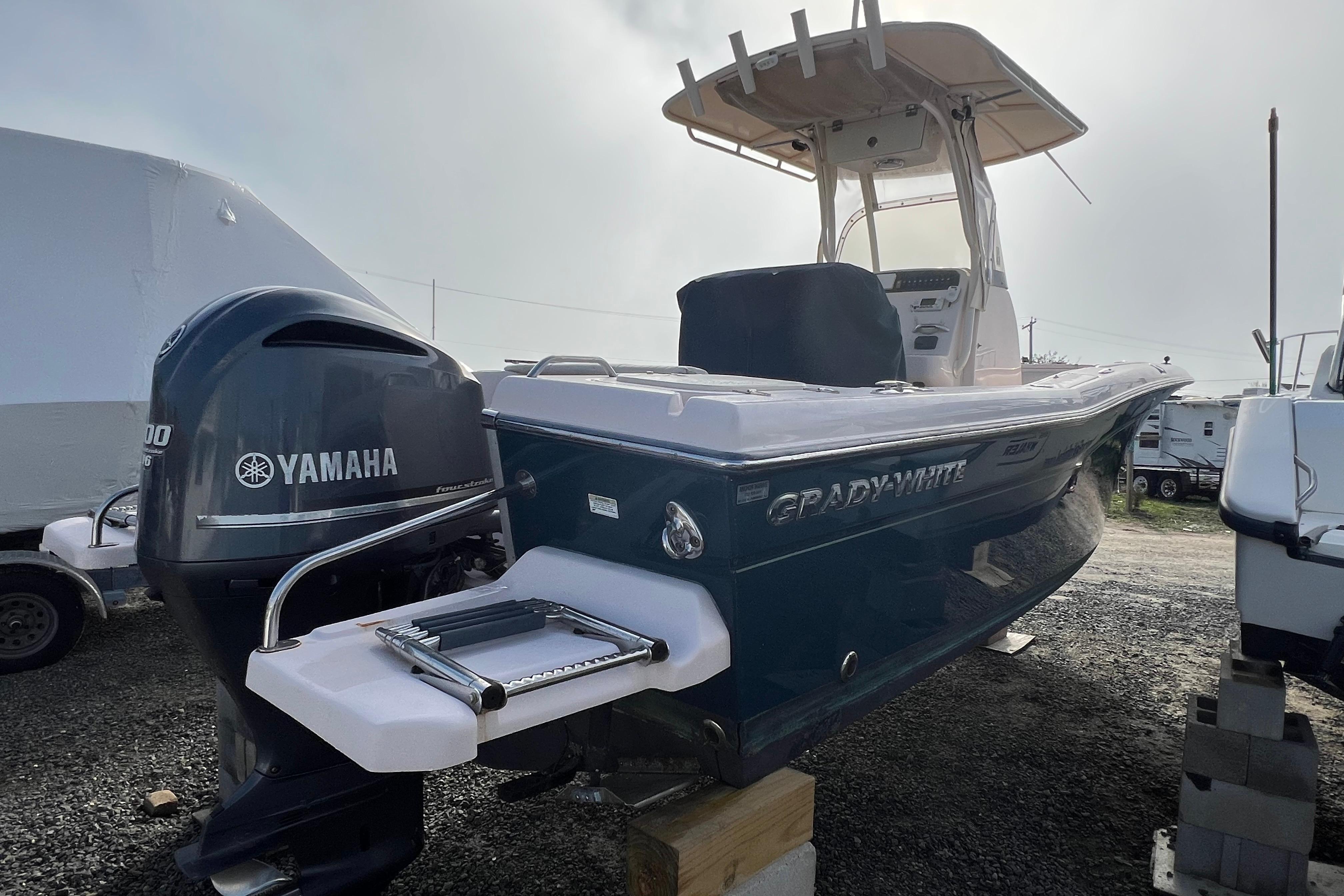 2014 Grady-White Fisherman 230 boat with Yamaha engine, parked outdoors.