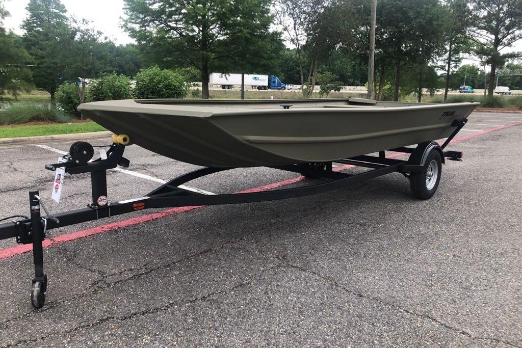 2026 Tracker Grizzly 1754 Utility boat on trailer in parking lot.